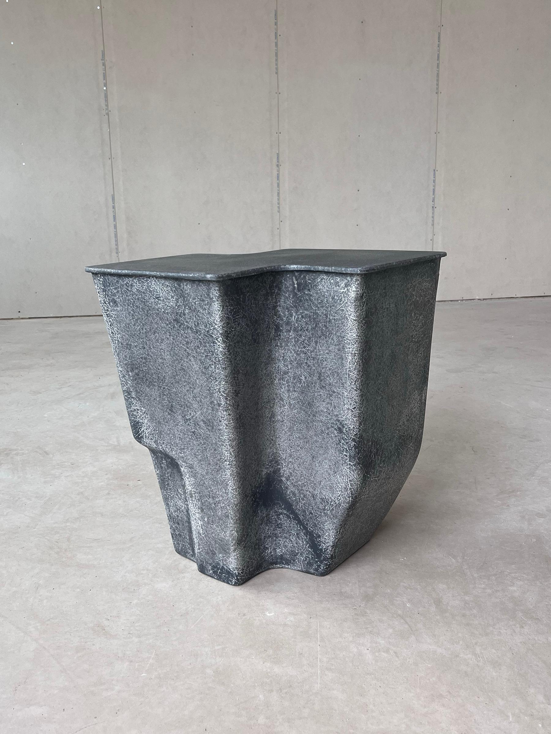 Clam Medium in raw fiberglass, part of our ‘unearthed’ collection. Inspired by the beautiful shells of the north, our Clam side table is made of unmasked fibreglass and plays with its natural transparency giving the material life. 

With an