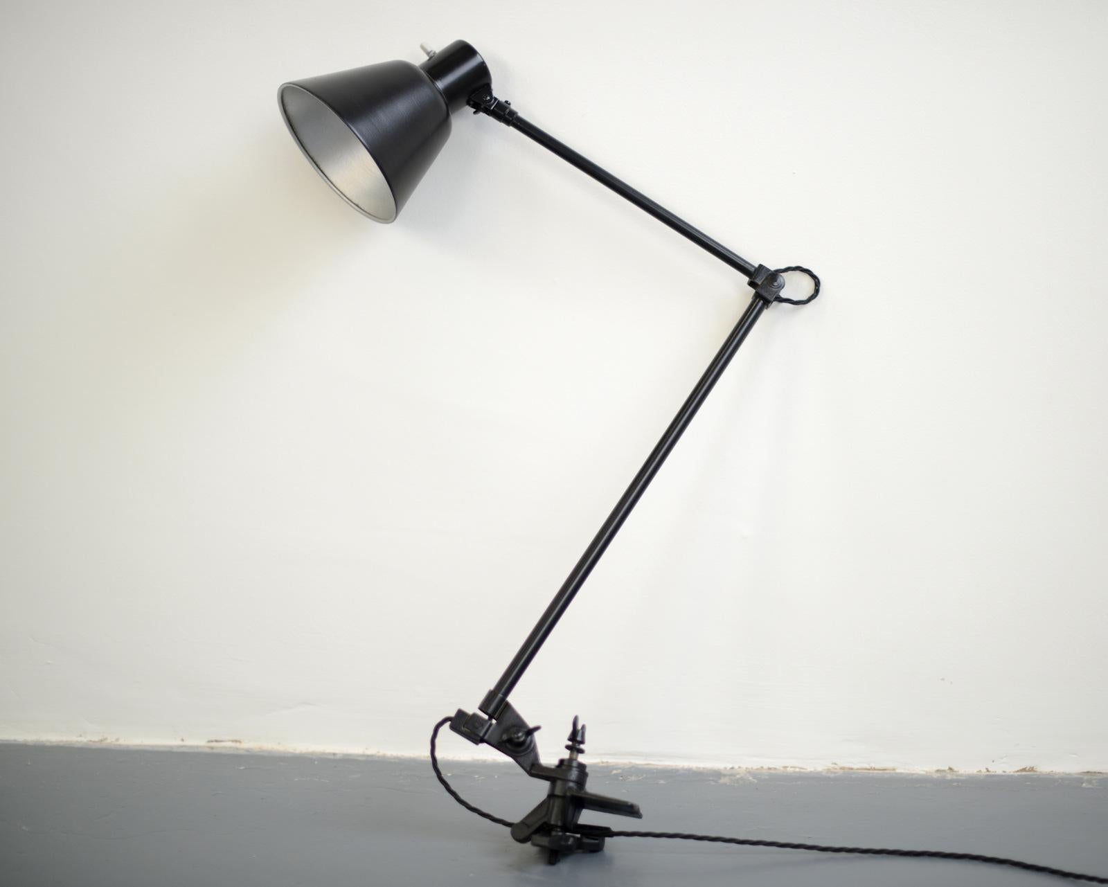 Clamp on industrial task lamp by Schaco, circa 1930s.

- Original porcelain switch
- Articulated arms
- Steel shade
- By Schanzenbach & Co, Frankfurt
- German ~ 1930s
- Measures: 91cm tall x 16cm wide x 45cm deep

Condition report

Fully