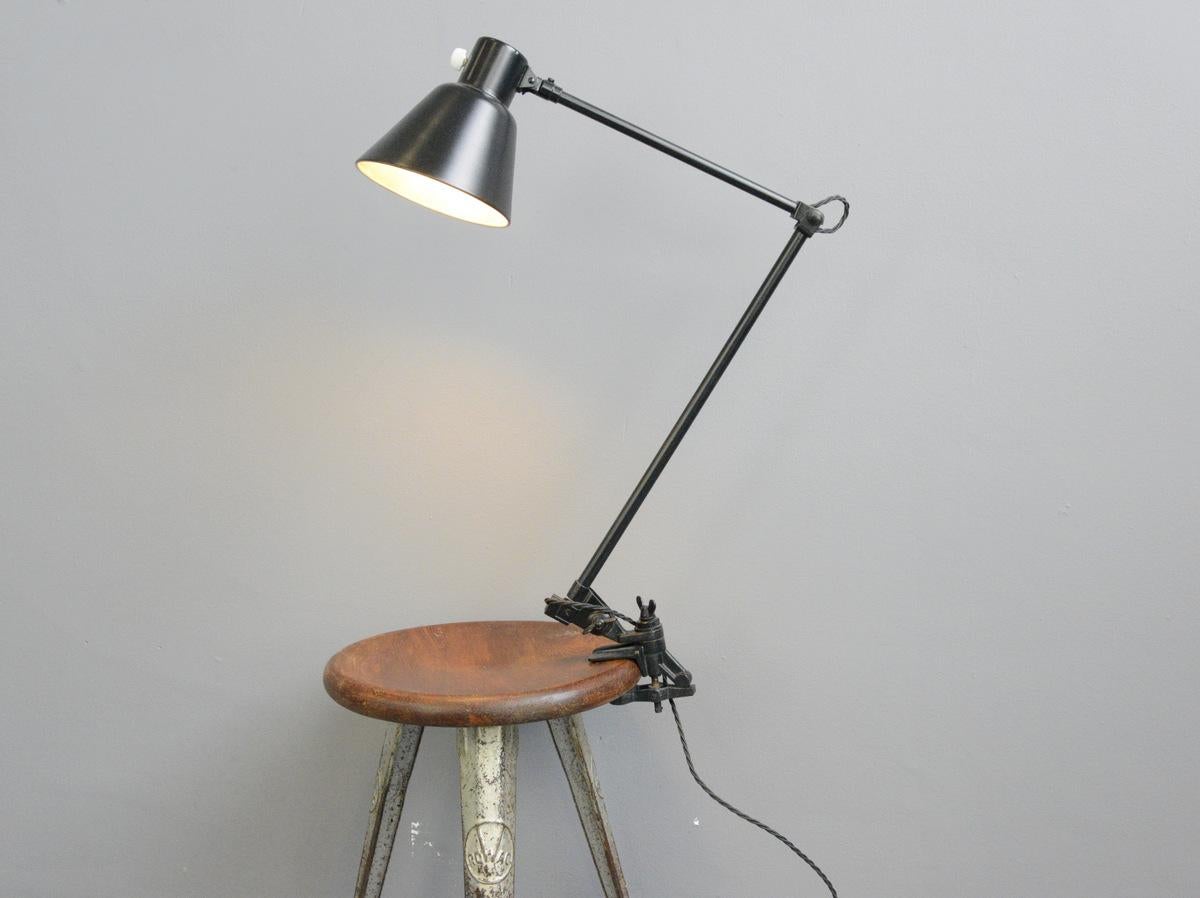 Clamp on industrial task lamp by Schaco, circa 1930s.

- Original porcelain switch
- Articulated arms
- Steel shade
- By Schanzenbach & Co, Frankfurt
- German, 1930s
- Measures: 91 cm tall x 16 cm wide x 45 cm deep

Condition