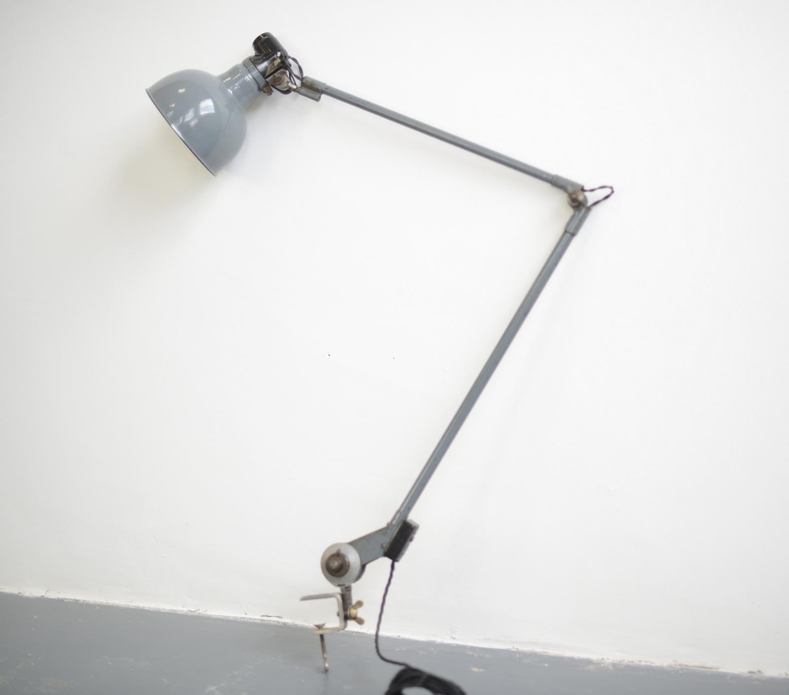 Clamp on task lamp by Ernst Rademacher, circa 1930s

- Vitreous dark grey enamel shade
- Bakelite switch
- Articulated arms
- By Ernst Rademacher
- German, 1930s
- Extends up to 120cm tall
- Shade measures 15cm wide

Condition