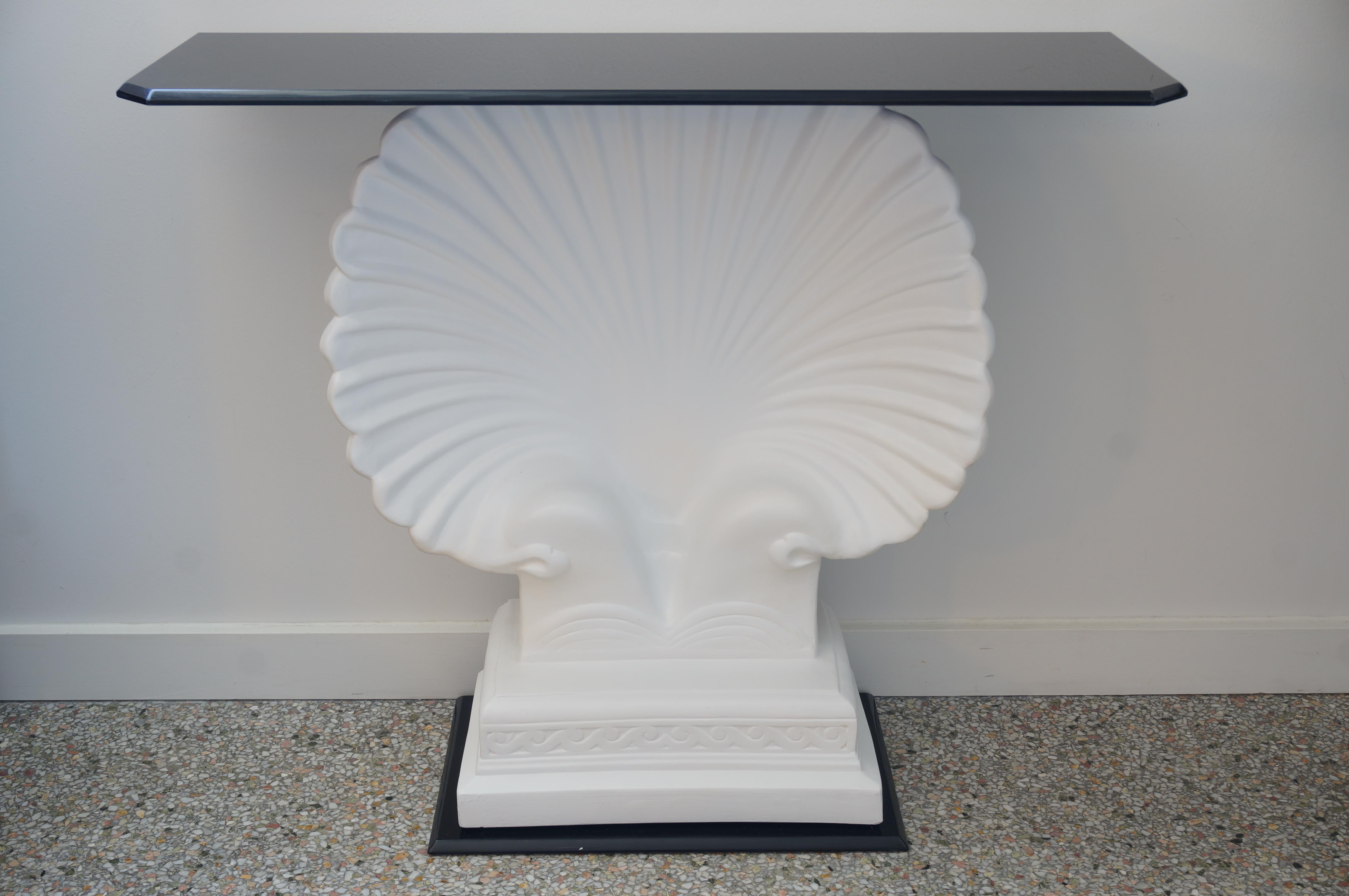 This stylish and chic clamshell form console table is a custom one-of-a-kind design and fabrication from Iconic Snob Galeries. The clamshell itself is made of cast plaster that has been pained white and the base and top are black lucite.

Note: