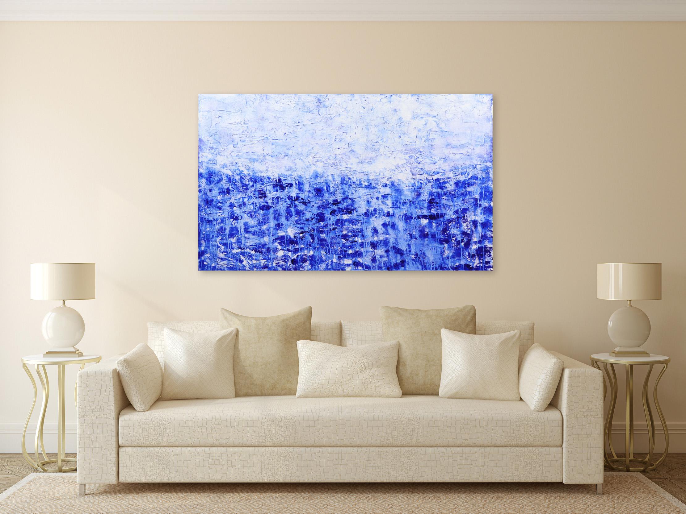 Clara Berta’s white and blue minimalist acrylic and mixed-media paintings blend texture and color to create harmony, mystery, and depth on the painted surface. Her abstract oceanscape paintings transform spaces into Zen environments where one can