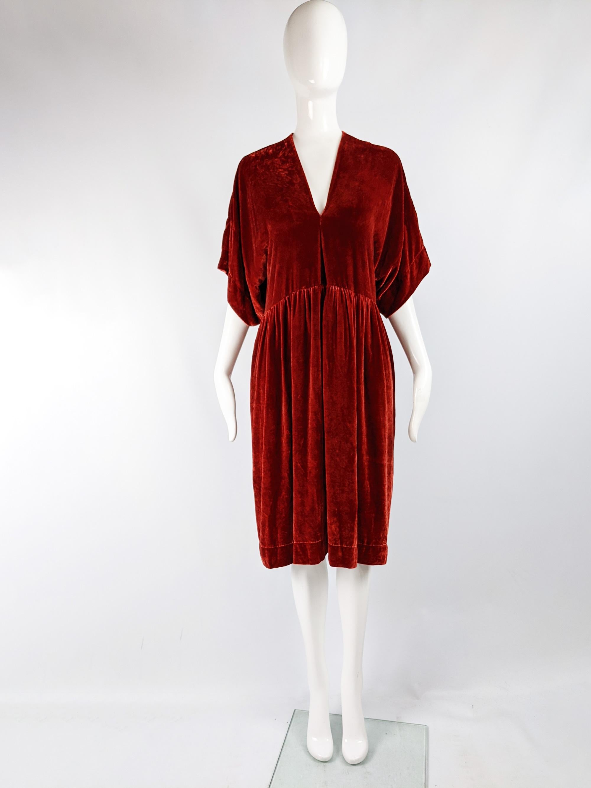A stunning vintage Clara Collins Paris dress from the 90s. In a deep red silk / viscose velvet with wide, kimono inspired sleeves and an oversized fit that drapes beautifully. 

Size: Marked international Size 3 which is roughly a Medium/ UK 12-14/
