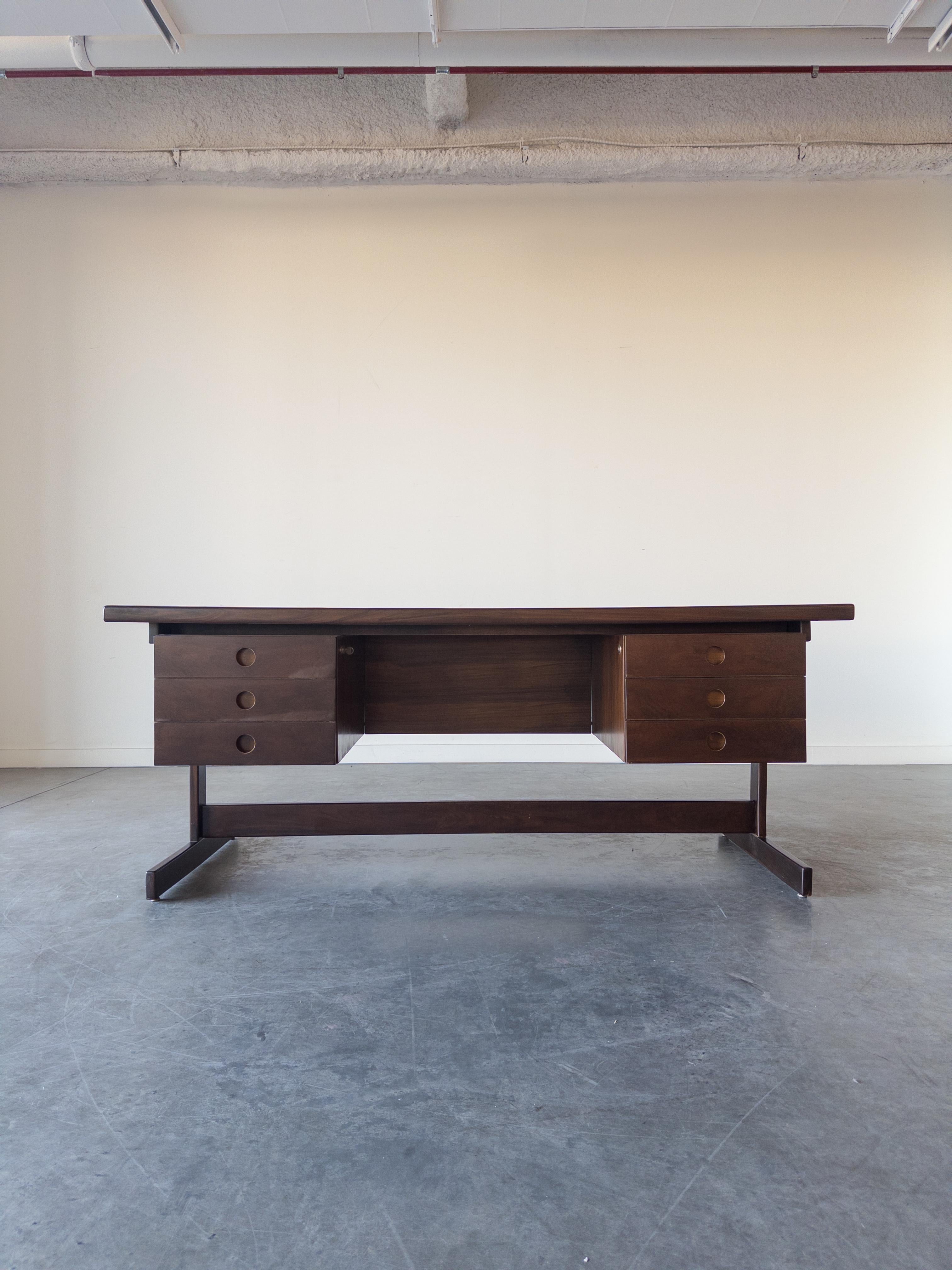 'Clara' Executive Desk by Sergio Rodrigues, 1960s, features beautifully grained Brazilian Caviona Wood, Aluminum, and signature trestle base with six drawers. Produced in circa 1960s by OCA Brazil.