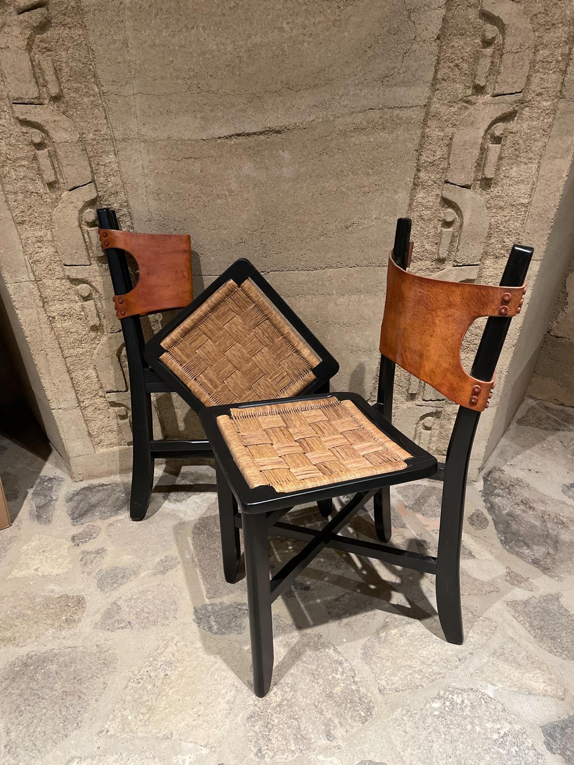 Folding Chairs
From Mexico circa 1950s. Clara Porset Folding Side Chairs. 
Listing is for 2 chairs.
Crafted in Leather and Handwoven Rush Cane with Wood frame painted black. 
Attributed to Clara Porset. Unmarked.
H 32.5 in. x W 14.75 in. x D 18.5