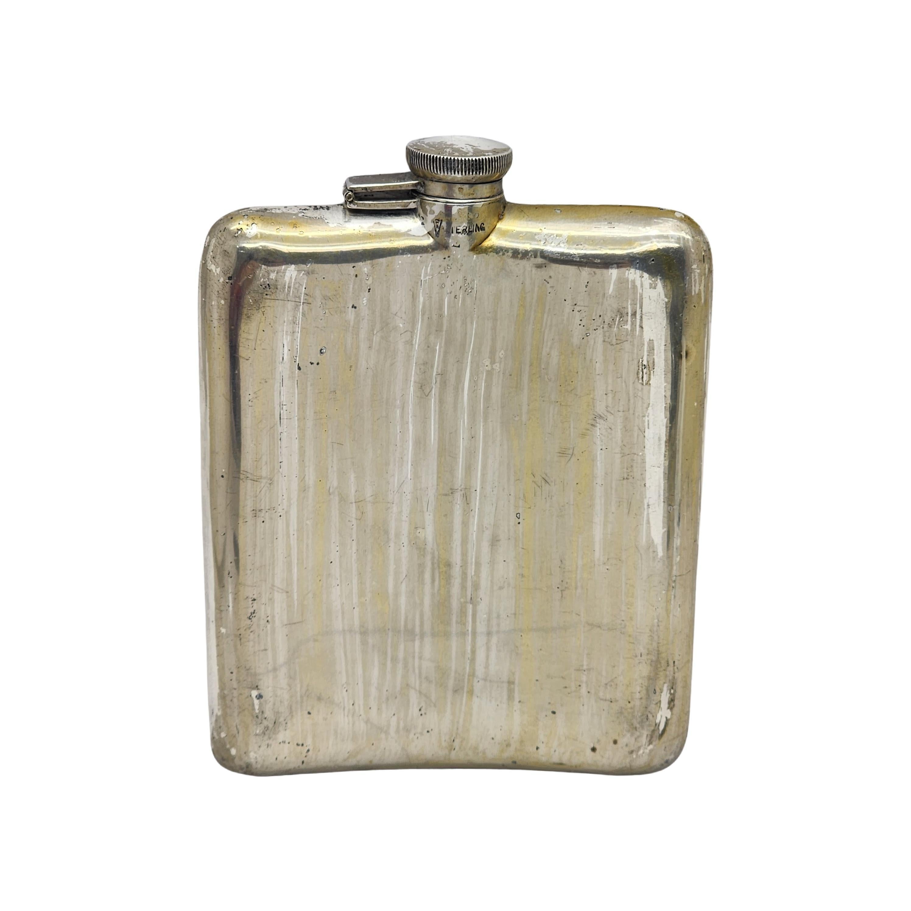 Sterling silver and black enamel hip flask by Clarence A. Vanderbilt with monogram.

Monogram appears to be ETRW

Curved hip flask featuring etched stripes with black enamel accents and a screw top with original inner cork.

Measures approx  5 1/2