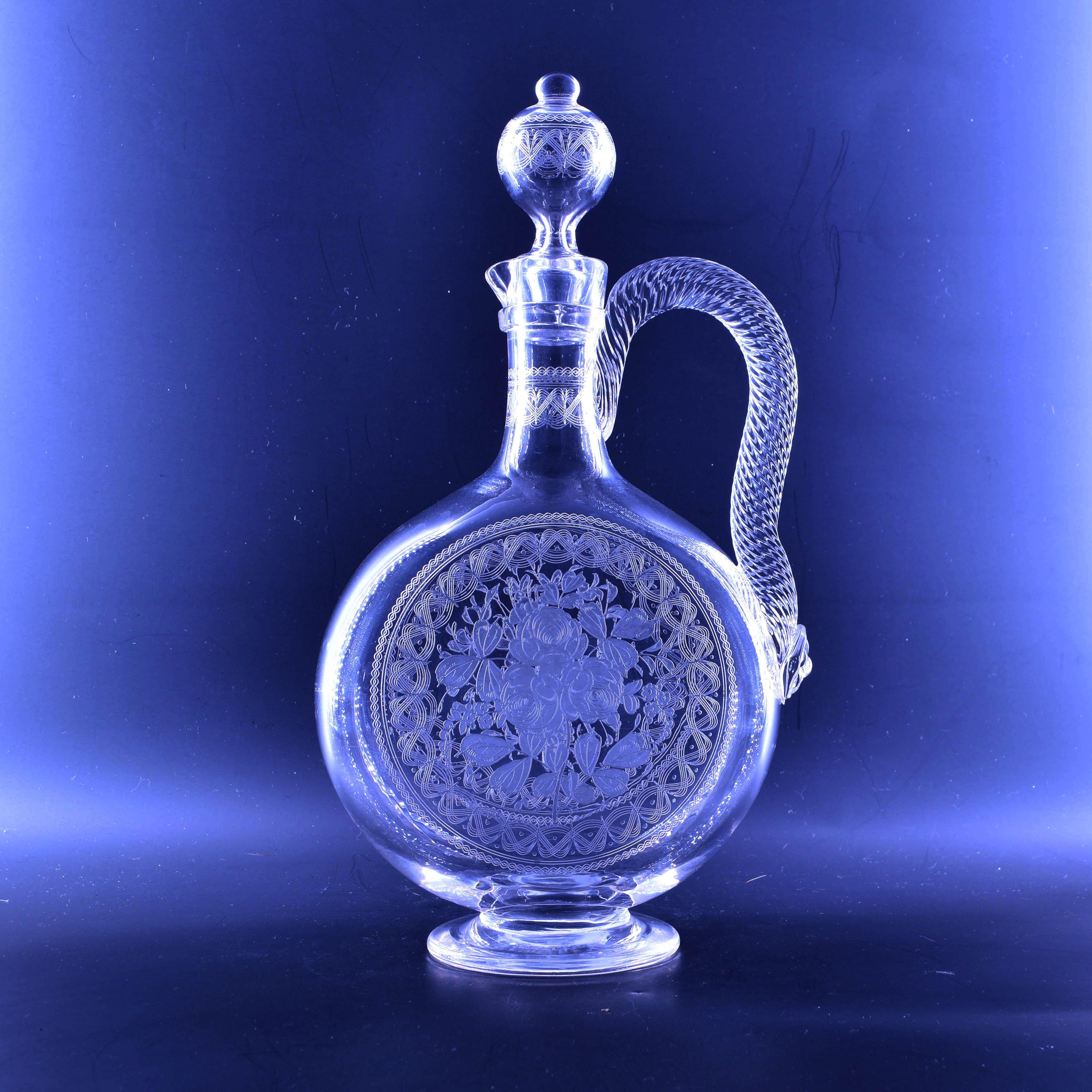 A 19th century Stourbridge claret jug, probably by Richardsons, of footed moon-flask form with slender neck, rope twist handle and hollow blown stopper, acid etched with cartouche panels of flowers and foliage.

Richardsons of Stourbridge was a
