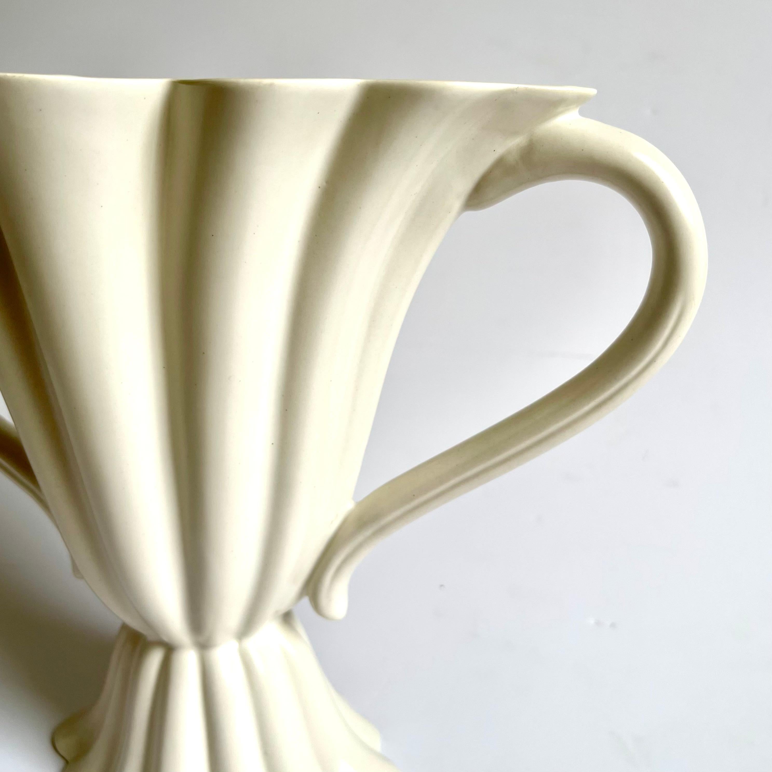 A very rare and large early Clarice Cliff for royal Staffordshire twin handled mantle vase. 
The all over cream glaze enhances the classic fluted lines and curved handles 
A truly dramatic piece of early twentieth century English pottery.
 