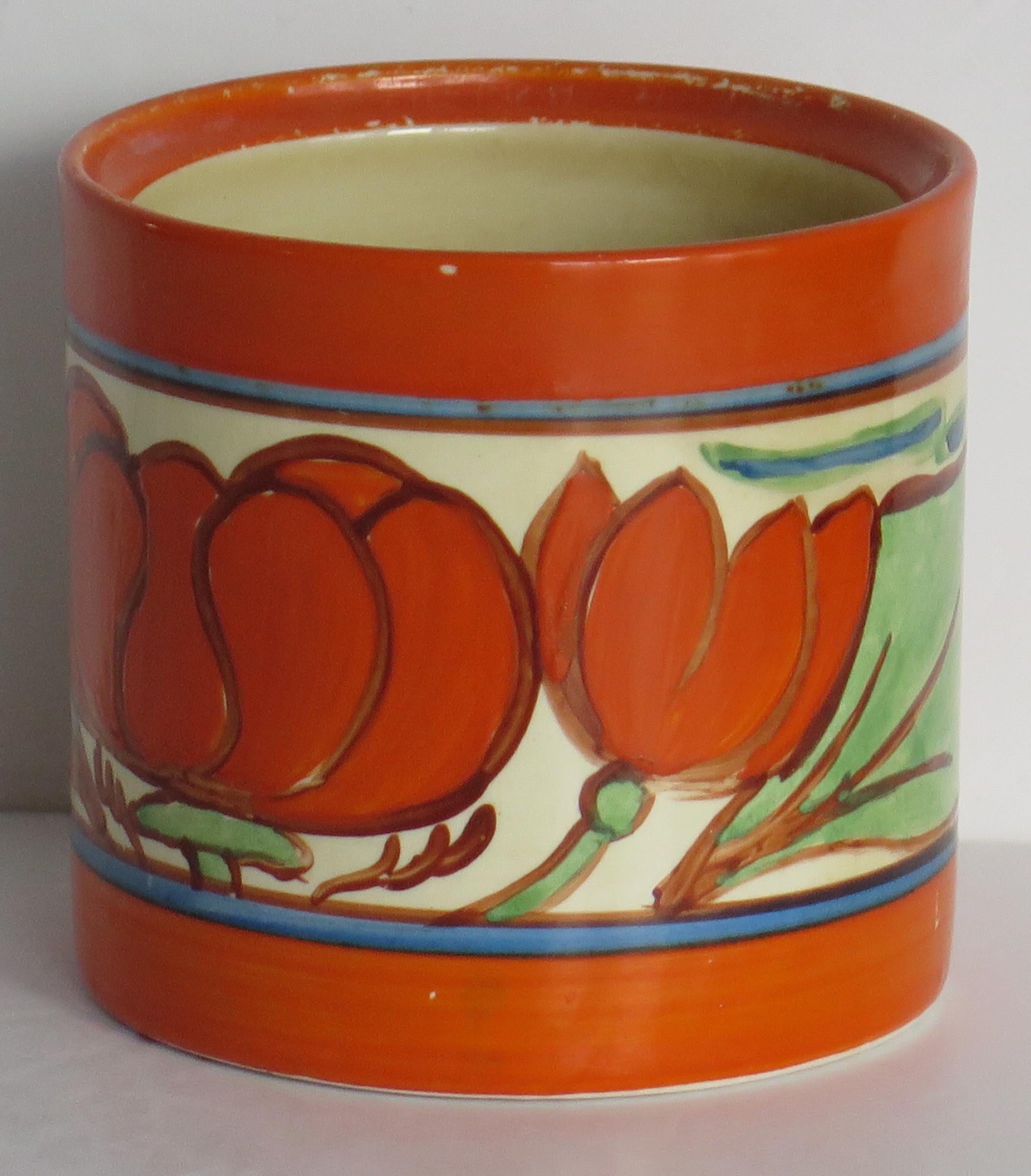 This is a circular pot in the rare, hand painted 