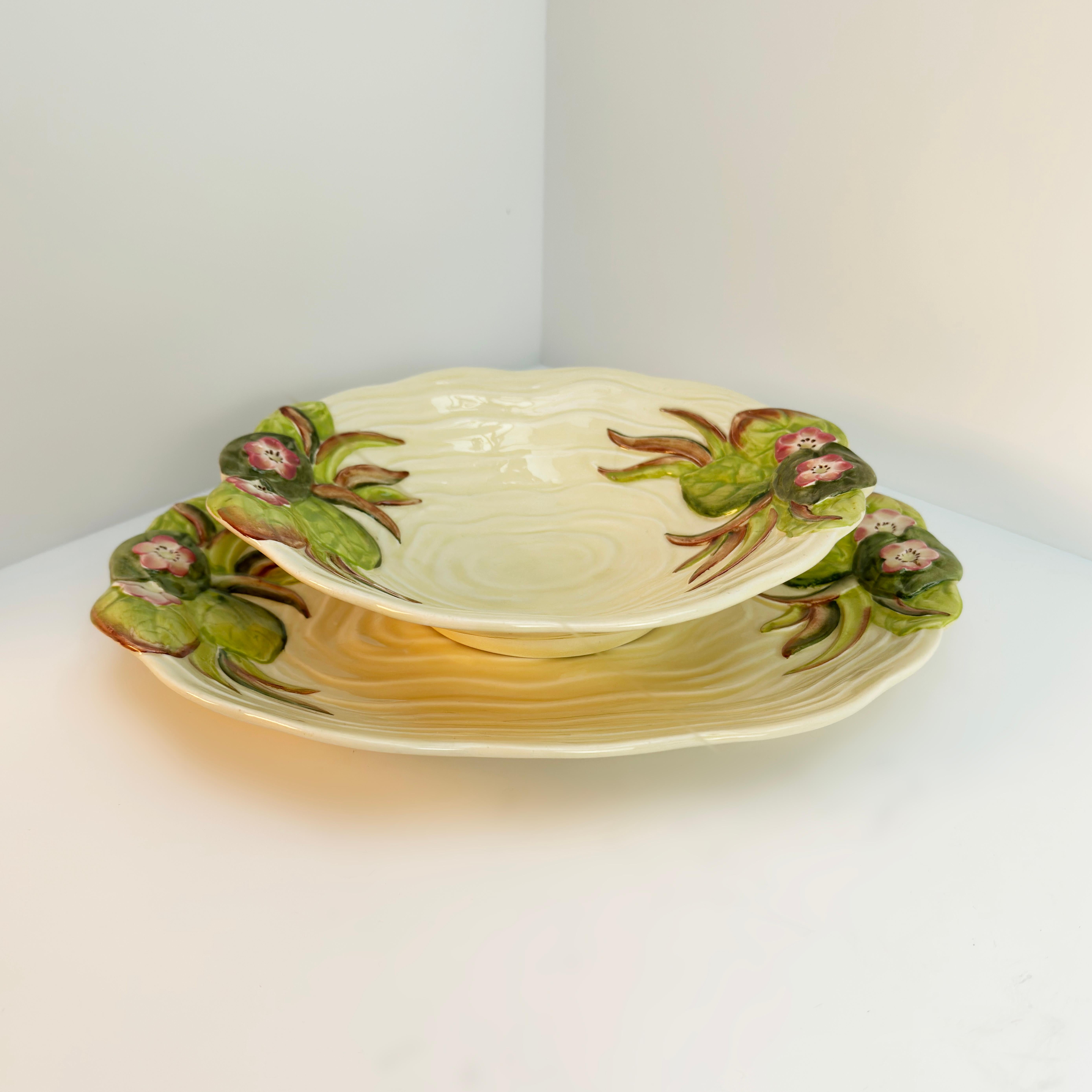 An Art Deco serving dish and  plate from Clarice Cliff's Water Lily collection for Newport Pottery in England

This beautiful serving plate and shallow dish will help you discover the whimsical charm of Clarice Cliff's beloved porcelain.

Crafted in