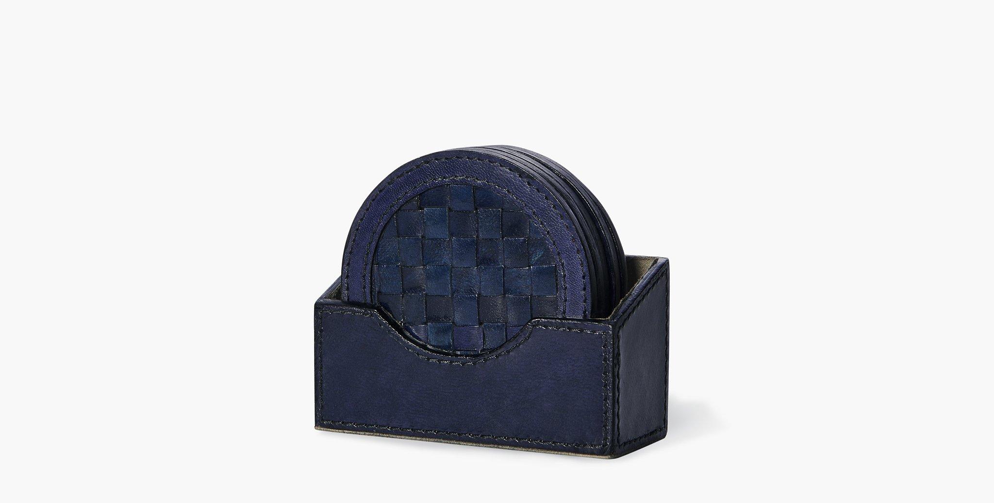 The Clarion Circle Coaster set displays a tightly woven leather design and makes a beautiful textural resting place for your beverages.

Basketweave leather design
Comes with 4 coasters and coaster tray
Imported