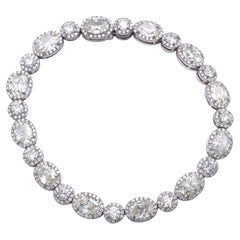Claris-A 13.36 Carat Oval and Round Diamond 18 Karat Gold Halo Tennis Bracelet Claris-A 13.36 Carat Oval and Round Diamond 18 Karat Gold Halo Tennis Bracelet