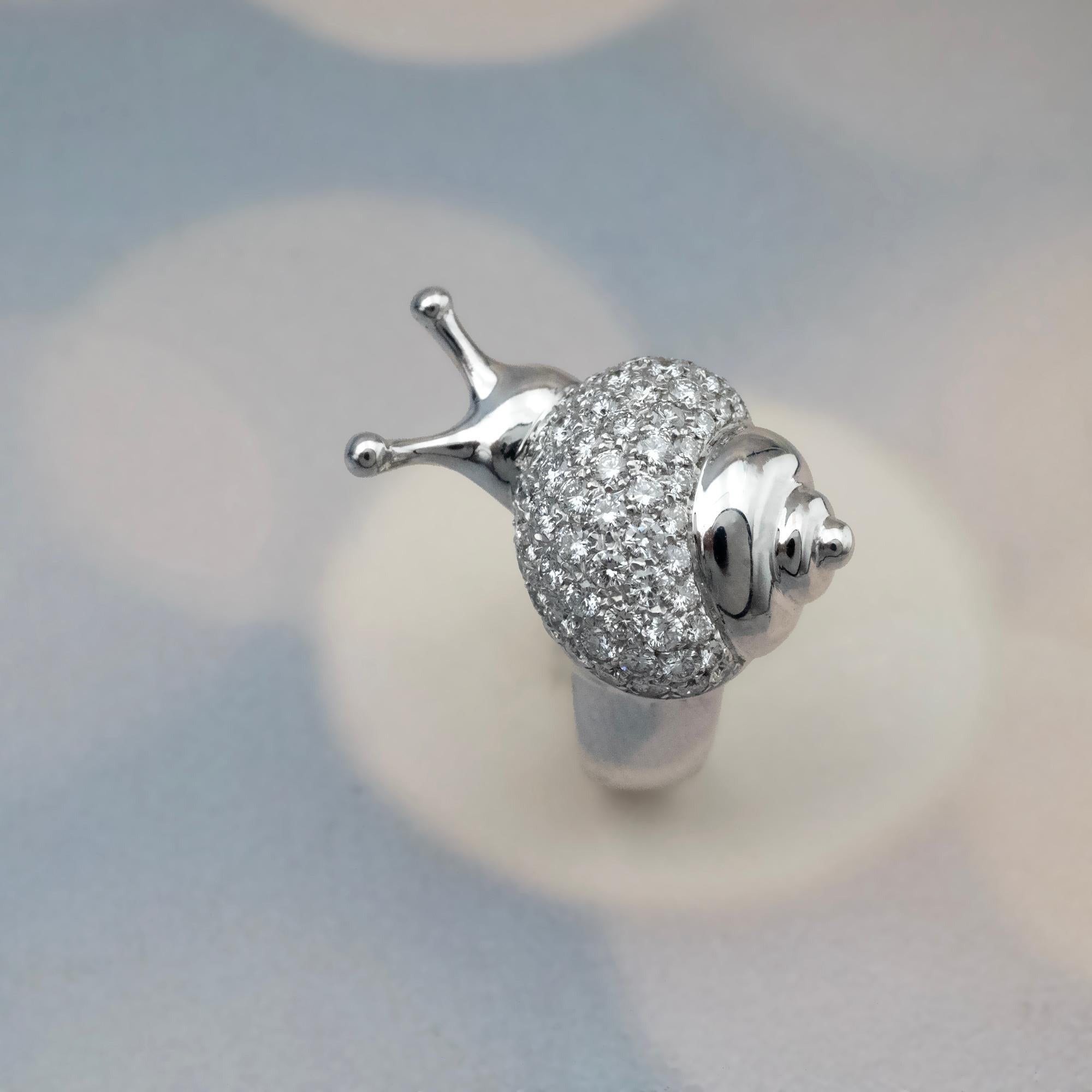 The Claris-A 18K White Gold Diamond Snail Ring is a refined example of sculptural jewelry, designed with a modern yet timeless aesthetic. The adorable snail's central motif features a clean and rounded silhouette. Its shell is adorned by