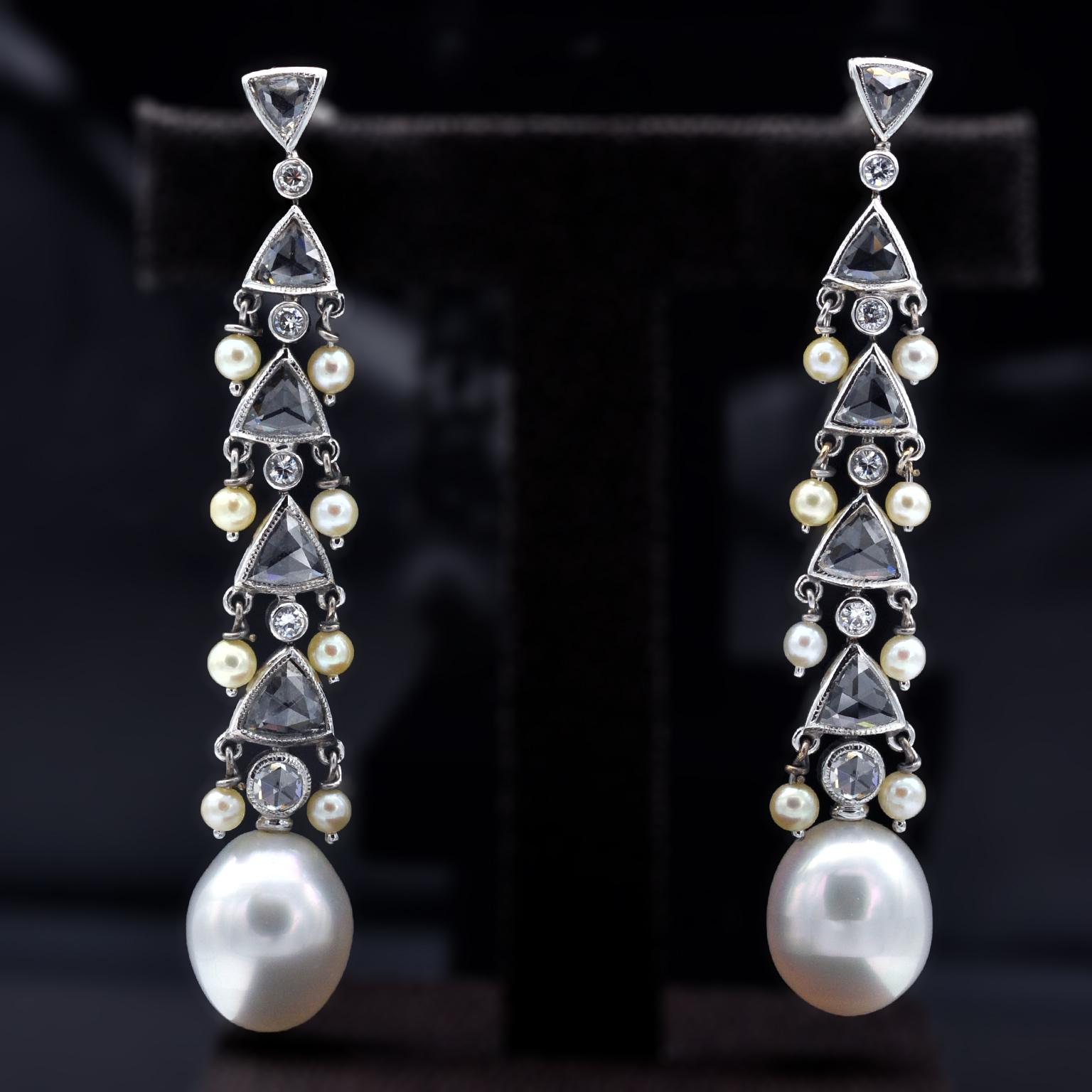 Classy One-of-a-kind chandelier Drop Earring: an egg shaped south-sea pearl hangs down a series of triangular rose cut diamonds from the sides of which dangle small round pearls. some full cut diamonds highlight the whole piece. 
A truly striking
