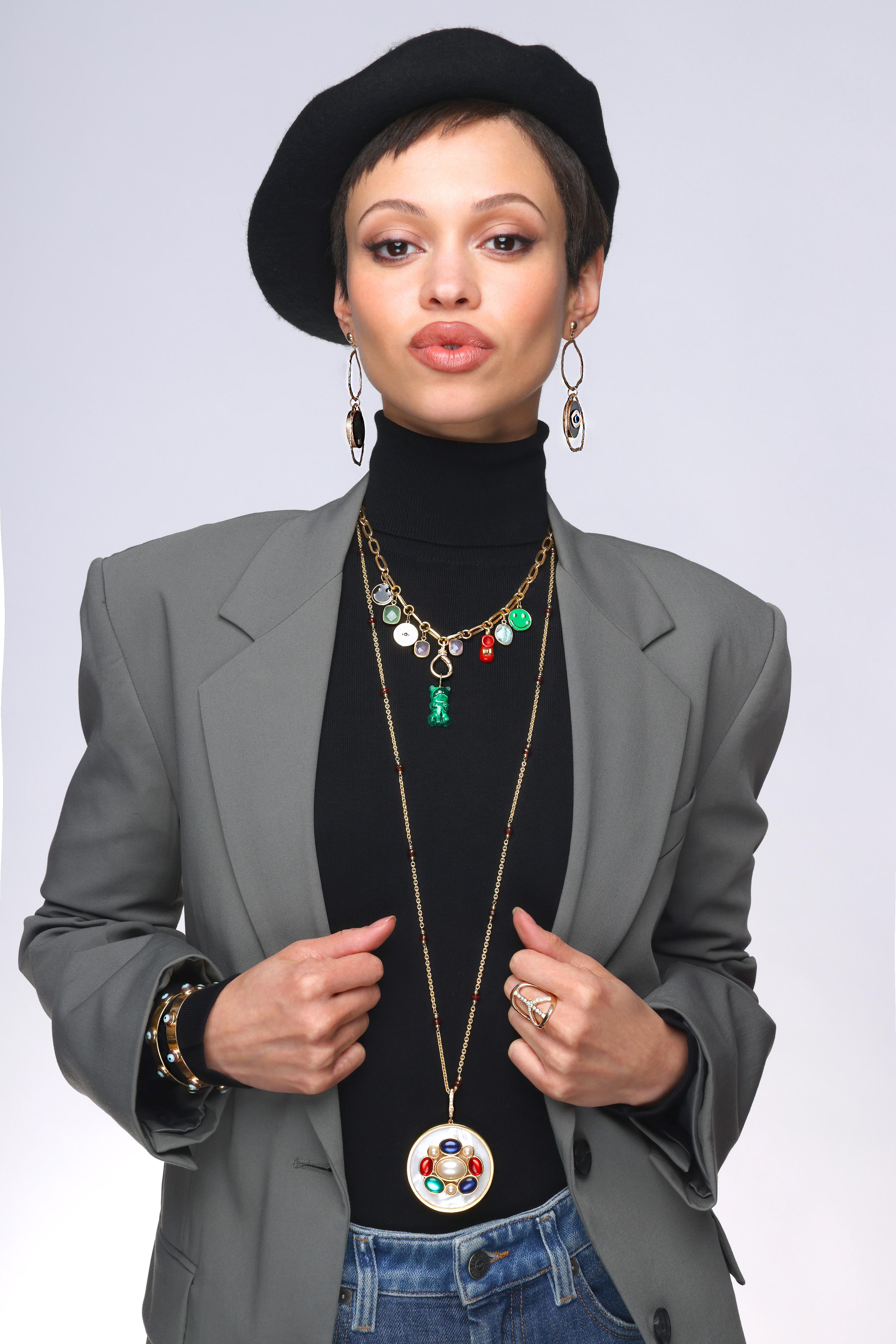 New Signature Mother-of-pearl pendant consists of:
A new signature design by Clarissa Bronfman. These pendants serve as multi purpose on short chains, long necklaces, Signature Symbol Tree Necklace top pendants, etc.

This pendant in particular