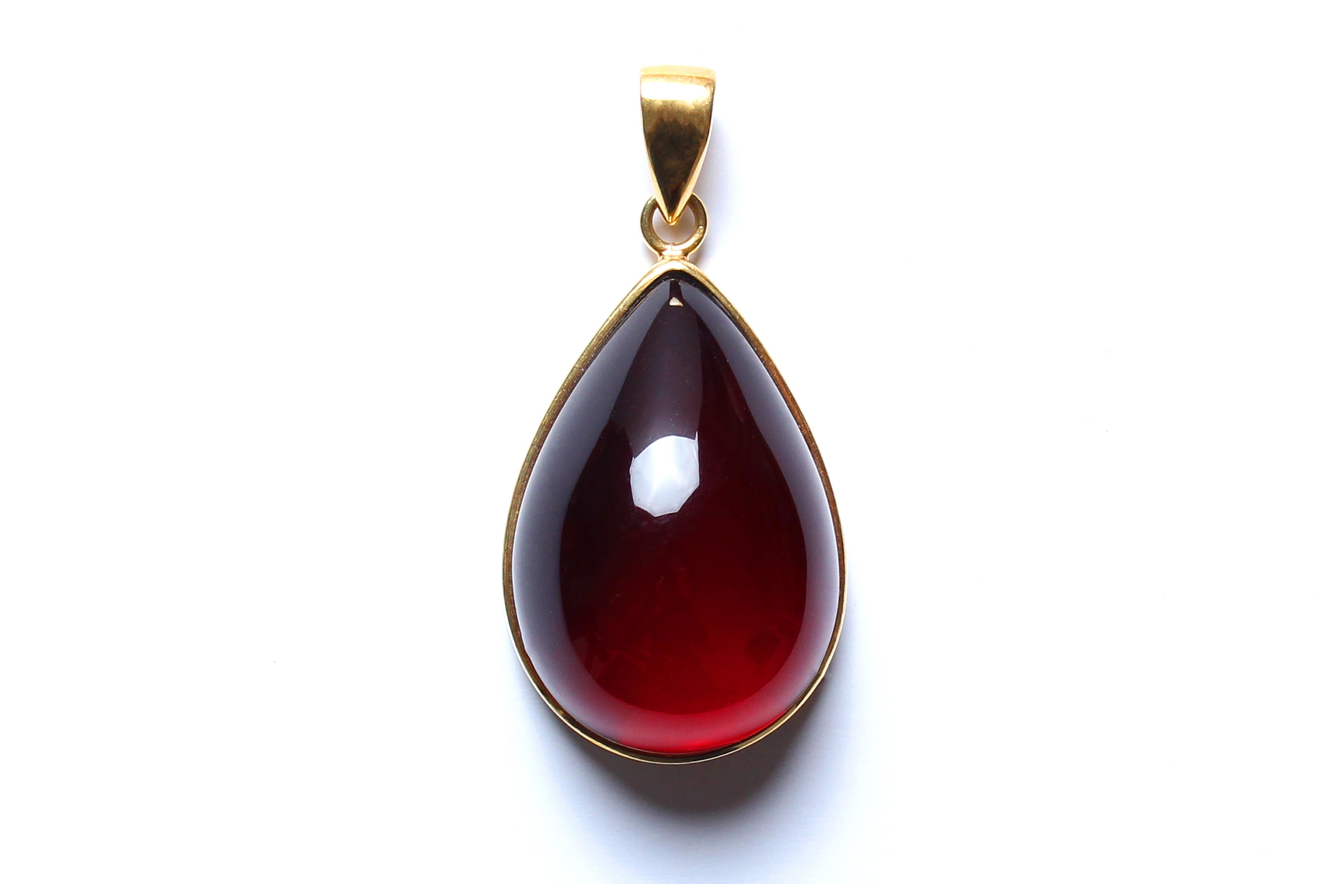 Elegant amber pendant made with diamond shape dark cherry amber and modern sterling silver frame