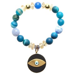 ClariSSA BRONFMAN Bracelet bleu en or, perles et ébène, œil de tigre ou œil maléfique