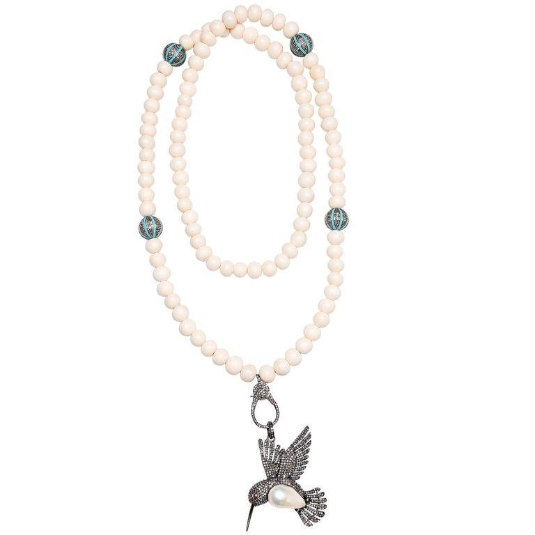 Bone beaded necklace with turquoise, diamond, and silver tumblers and clasp. 37