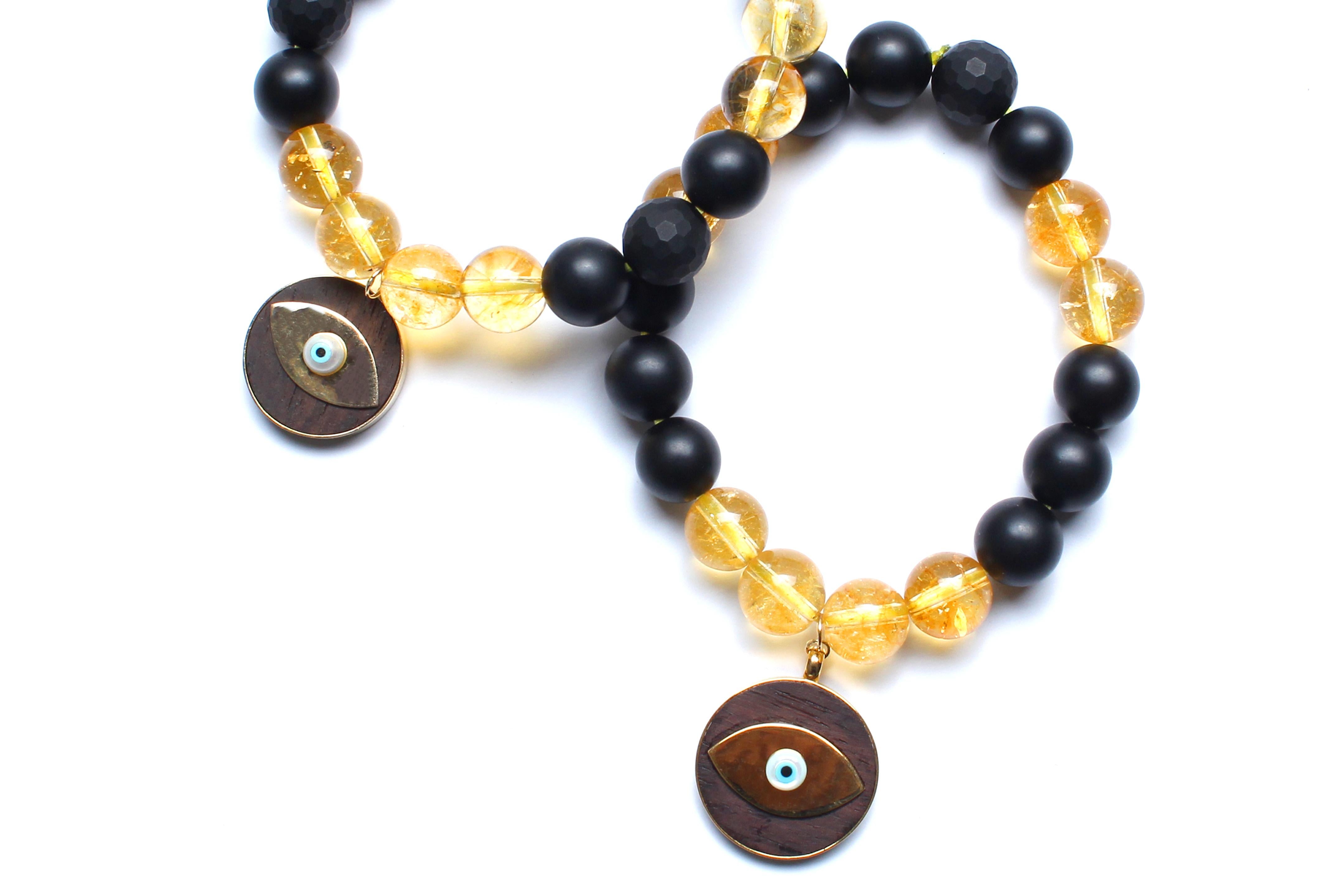 Onyx, ebony, enamel, citrine, 14k gold bracelet.

Elastic fit. 7.5
