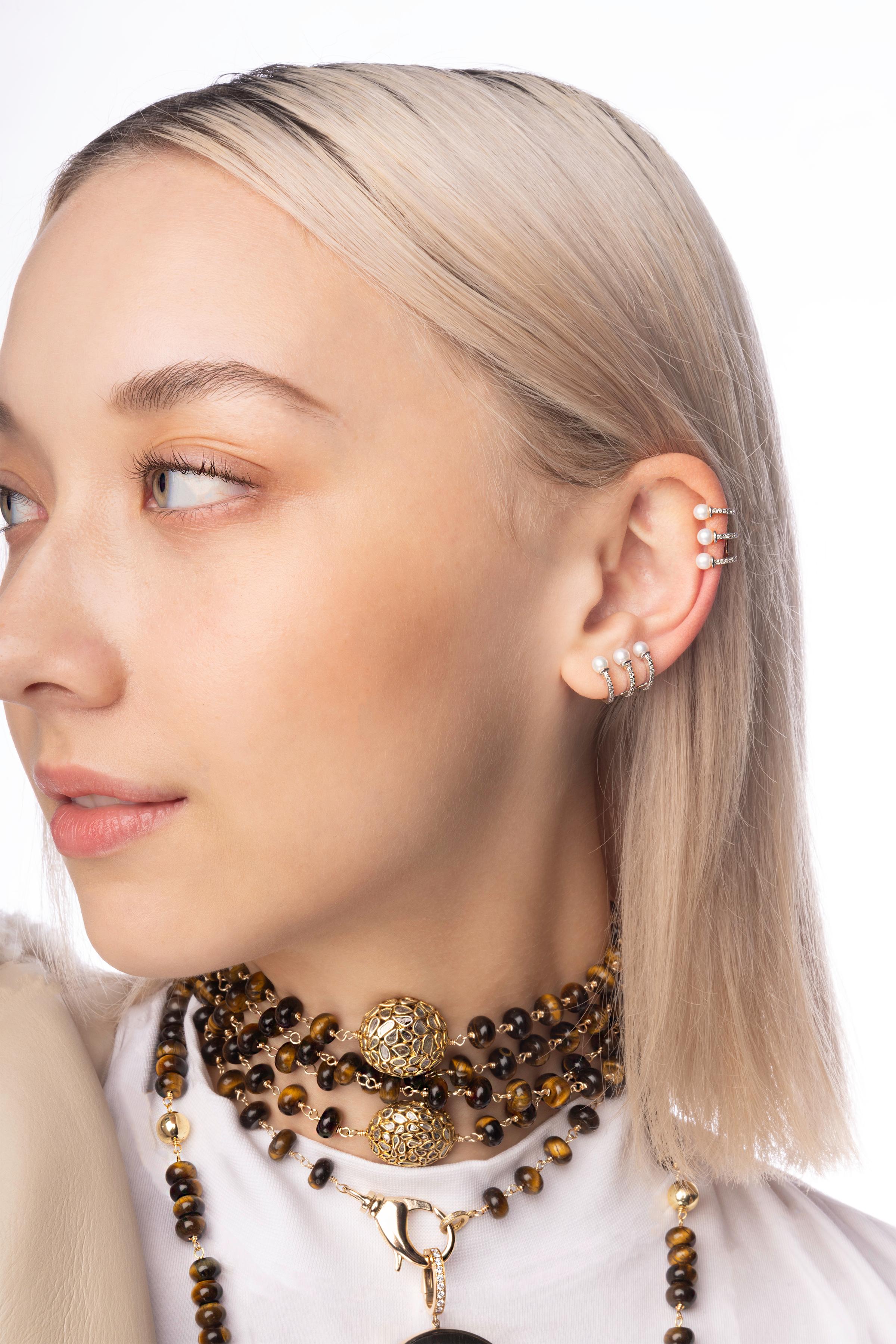 This signature piece has been custom designed to give your ear that custom diamond/pearl glow!

At approximately half an inch in length, you do not need a cartlidge ear piercing to wear this. It is bendable to fit to your ear.

Composed of 14k gold,
