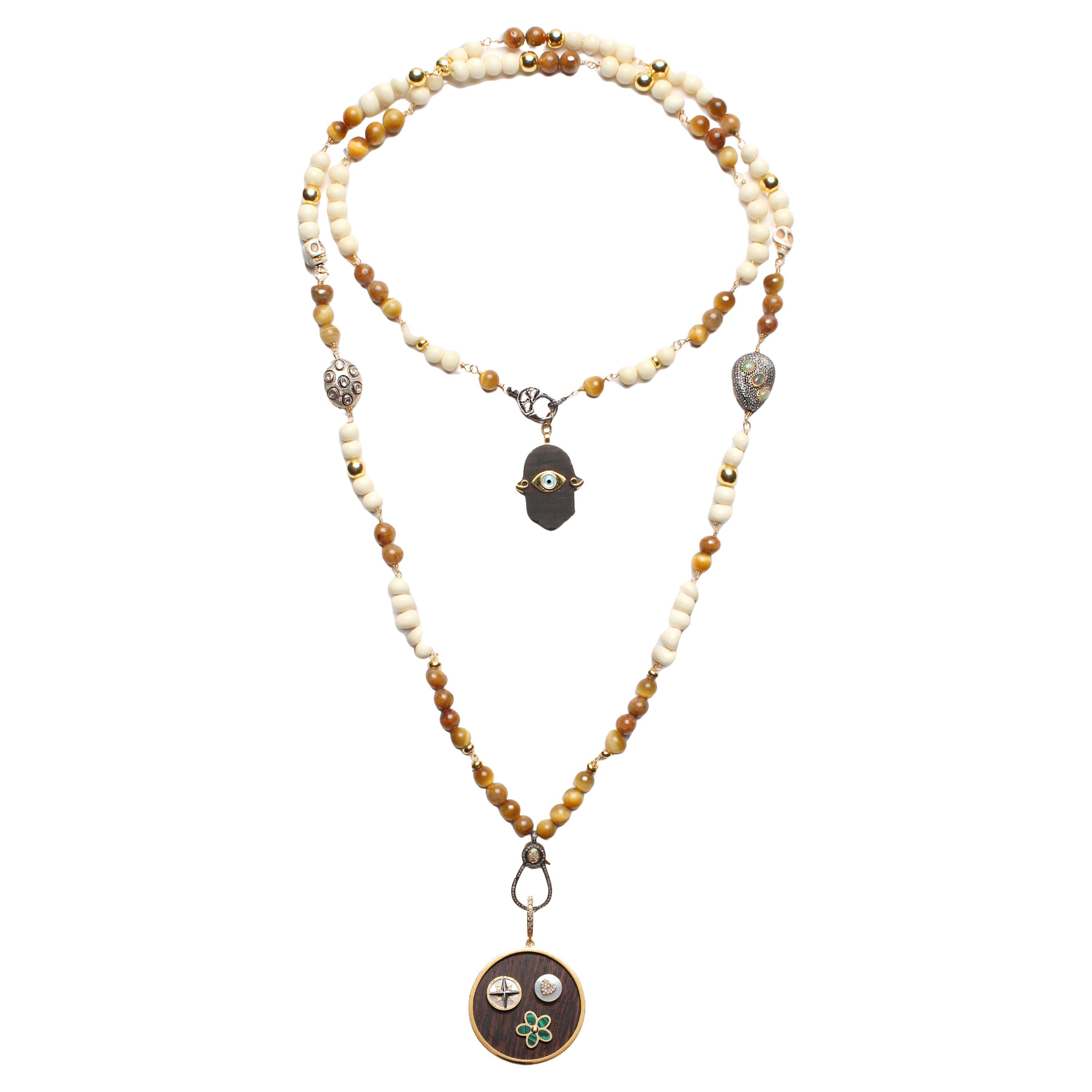 Clarissa Bronfman - Collier Carmen en os d
oeil de tigre et pendentifs en ébène avec arbre de vie