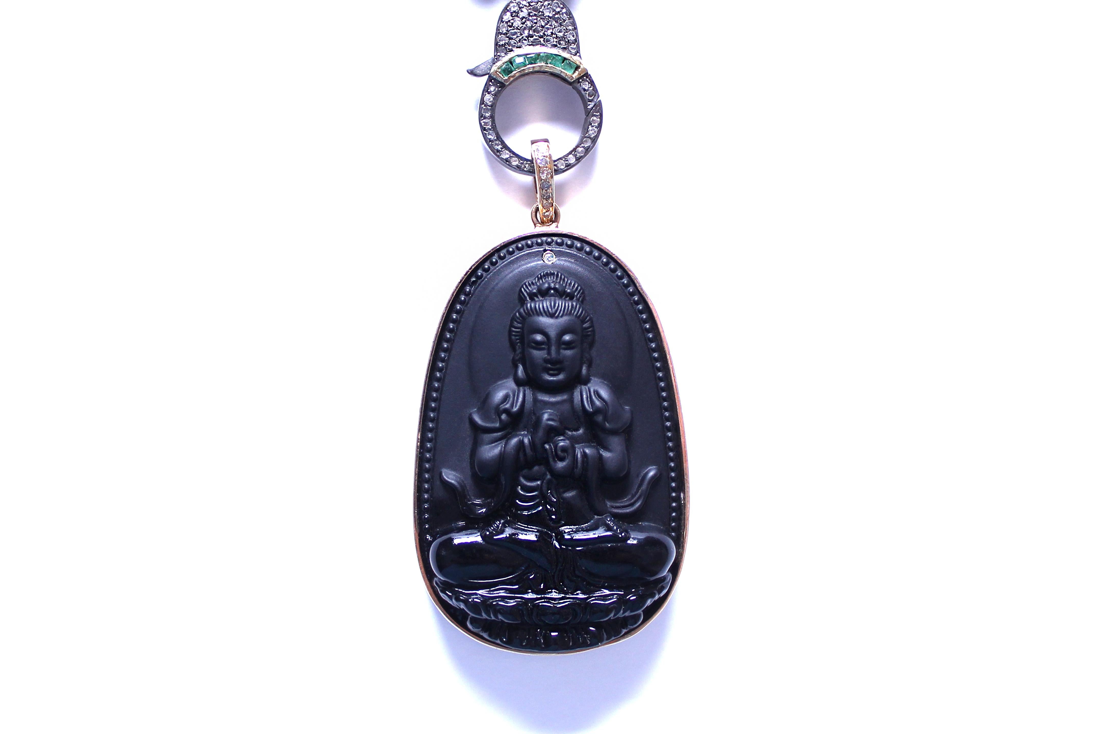 Pendant consists of:
Indonesian hand carved volcanic buddha rock. 14k gold frame. 14k gold bail with diamonds. 14k gold framed diamond on top. 
2
