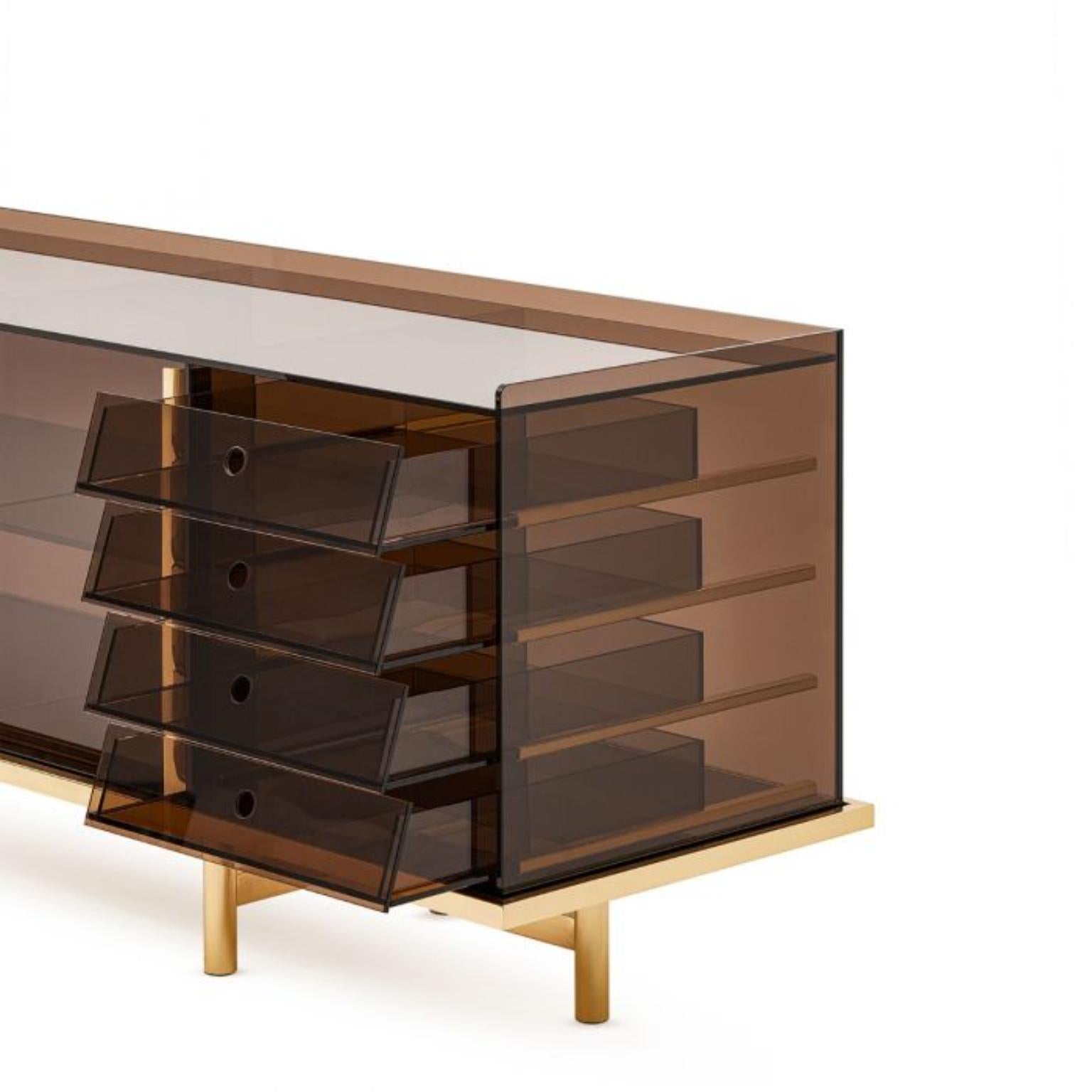 Clarity Sideboard by Ginger & Jagger
Dimensions: D 61 x W 225 x H 81 cm. 
Materials: Glass and brass.
Finish: Glass in Bronze finishing. Metal details: Polished Brass.

This product is suitable for custom size. This product is made for living areas