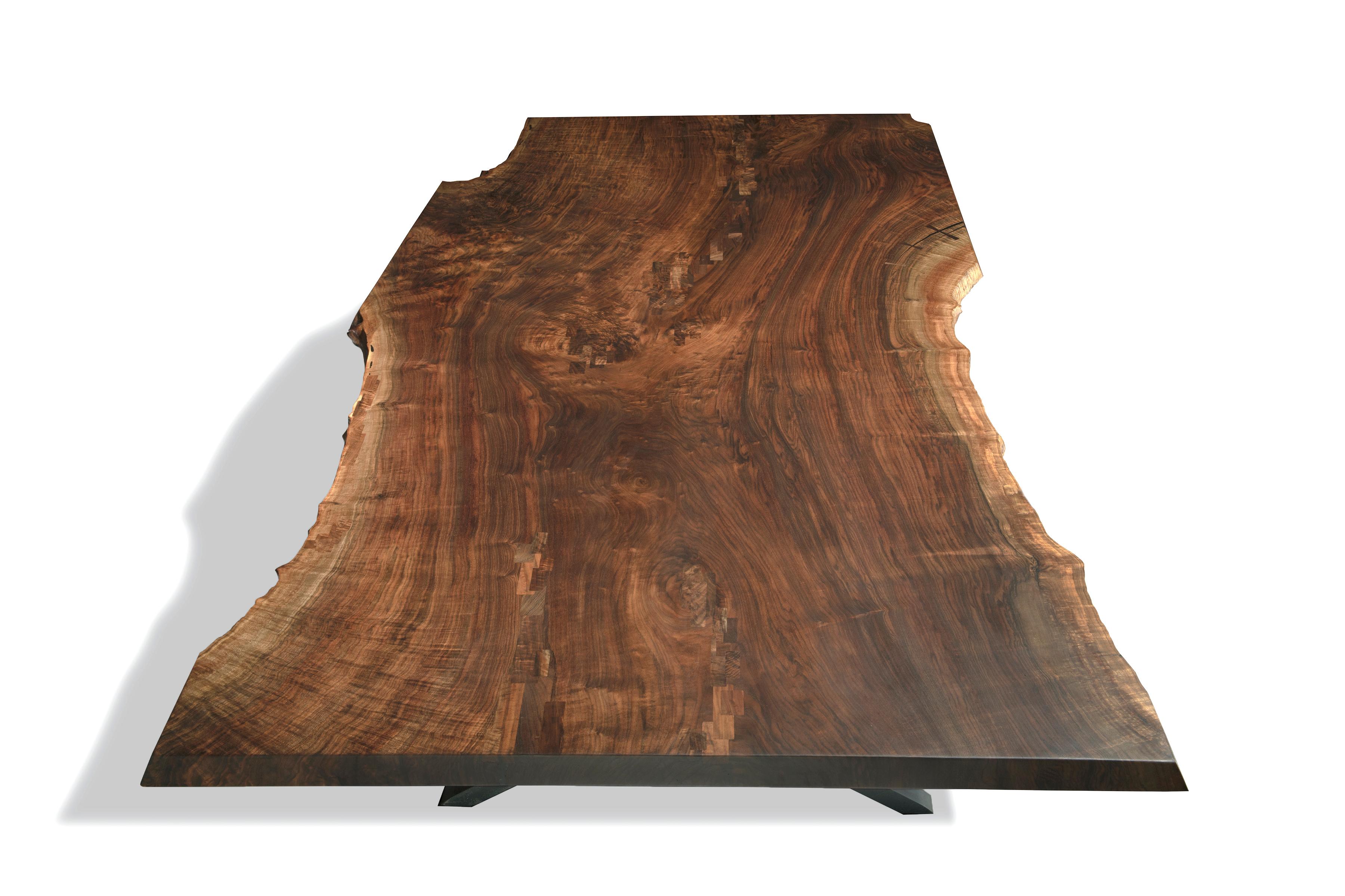 A huge single slab of museum grade California Claro walnut set atop oversized steel wishbone legs. Handcrafted from one of our 