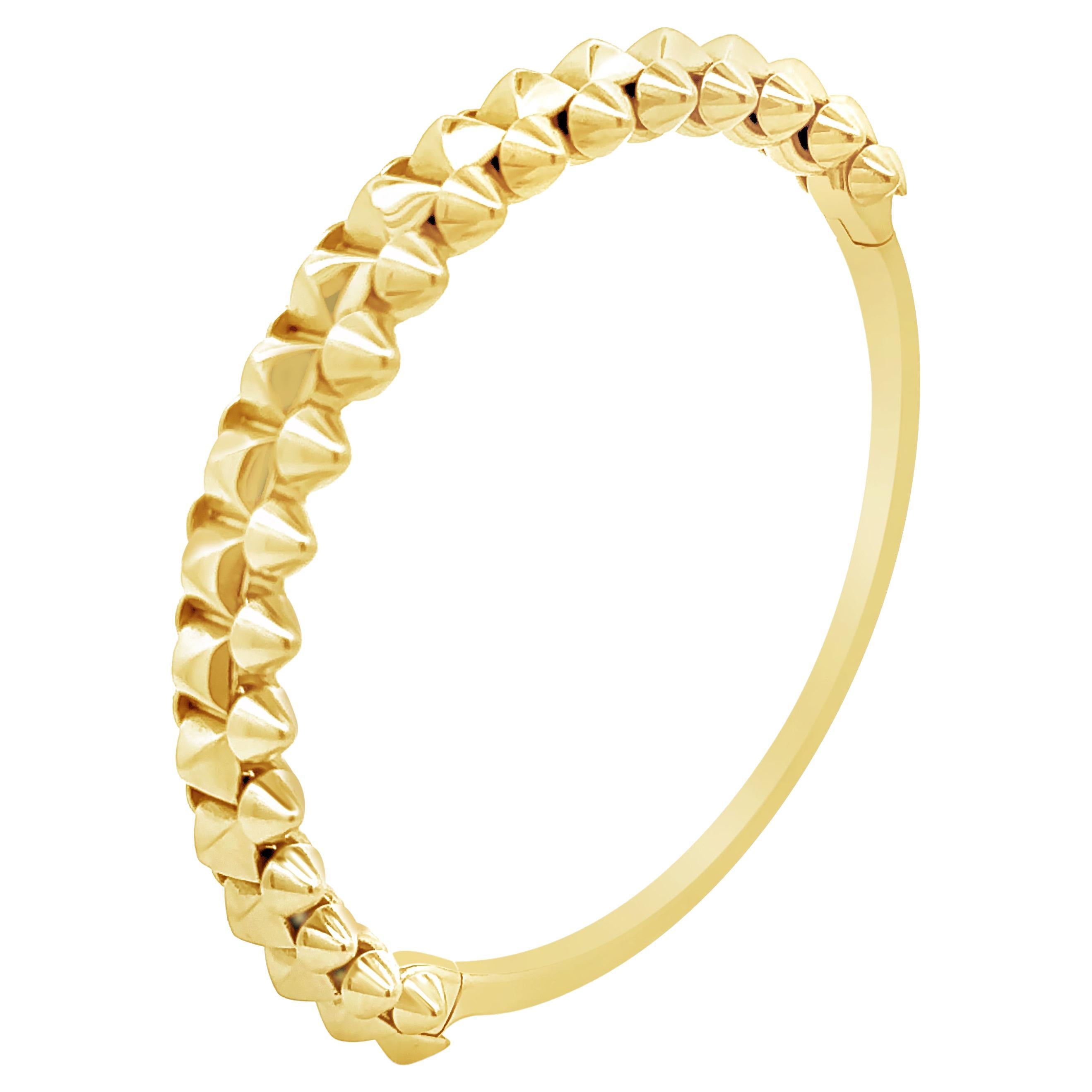 A magnificent bangle bracelet, featuring one row of pyramids surrounded by moving cones, set in a half-way design. Size 15, extra large version.

This fashionable bangle weighs 47.80 grams and 12.45 mm in width. Created by renowned jewelry house