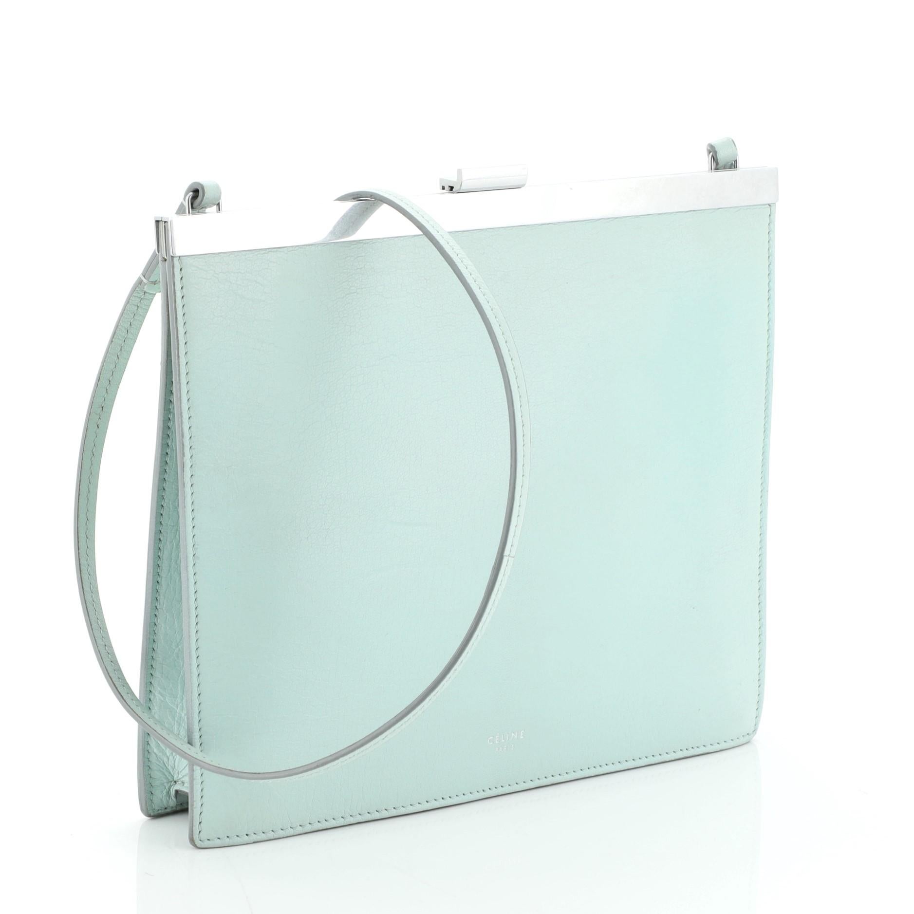 This Celine Clasp Crossbody Bag Leather Mini, crafted in green leather, features slim leather shoulder strap, stamped Celine logo, framed top, and silver-tone hardware. Its clasp closure opens to a yellow leather interior with slip pockets.