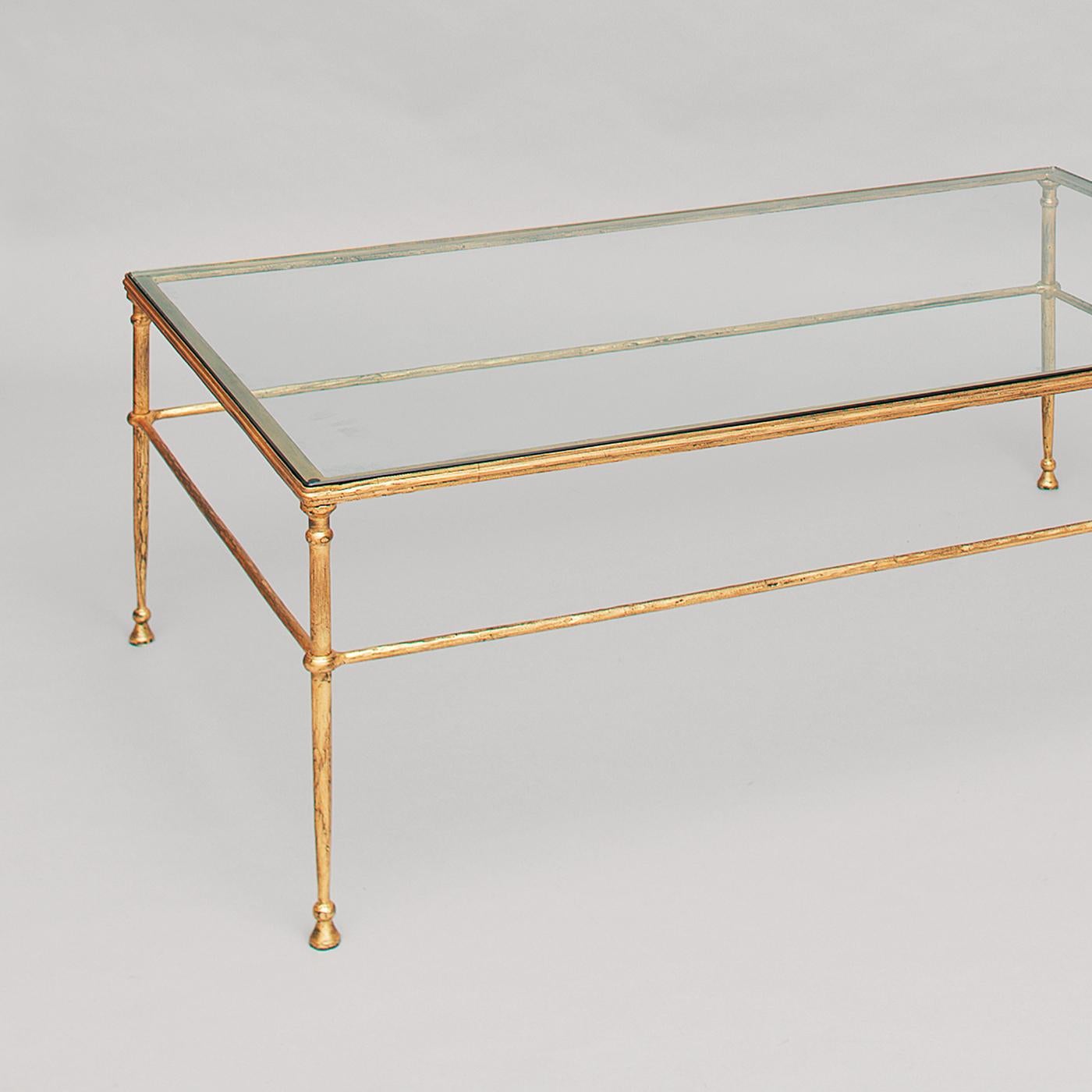 The sophisticated design of this tall coffee table evokes ancient Roman and Etruscan furniture, with their slender metal structures and harmonious proportions. The table's stainless steel elements create a net of delicate lines adorned with rings at