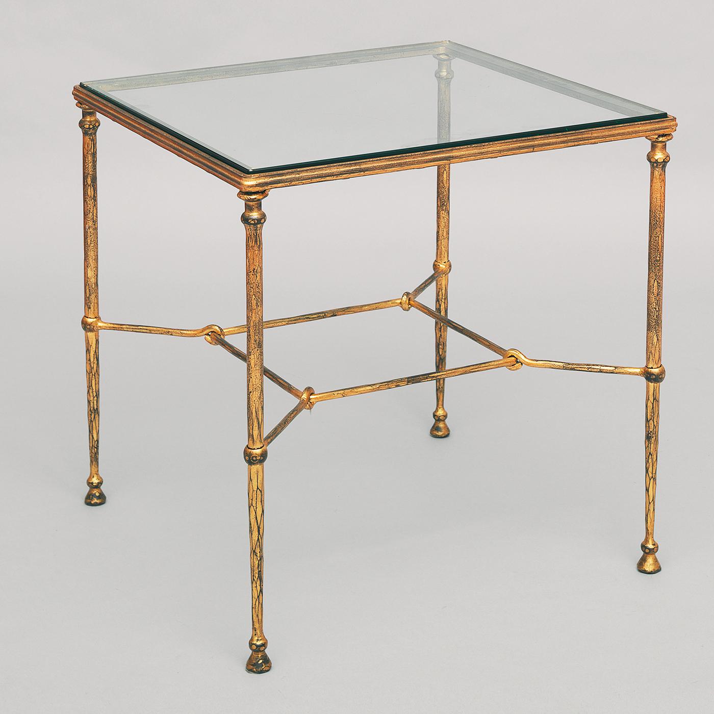 This superb coffee table will make an elegant statement in both traditional and contemporary interiors. The stainless steel structure evokes the splendors of ancient Roman and Etruscan decors, comprising a square crystal top supported by a base with