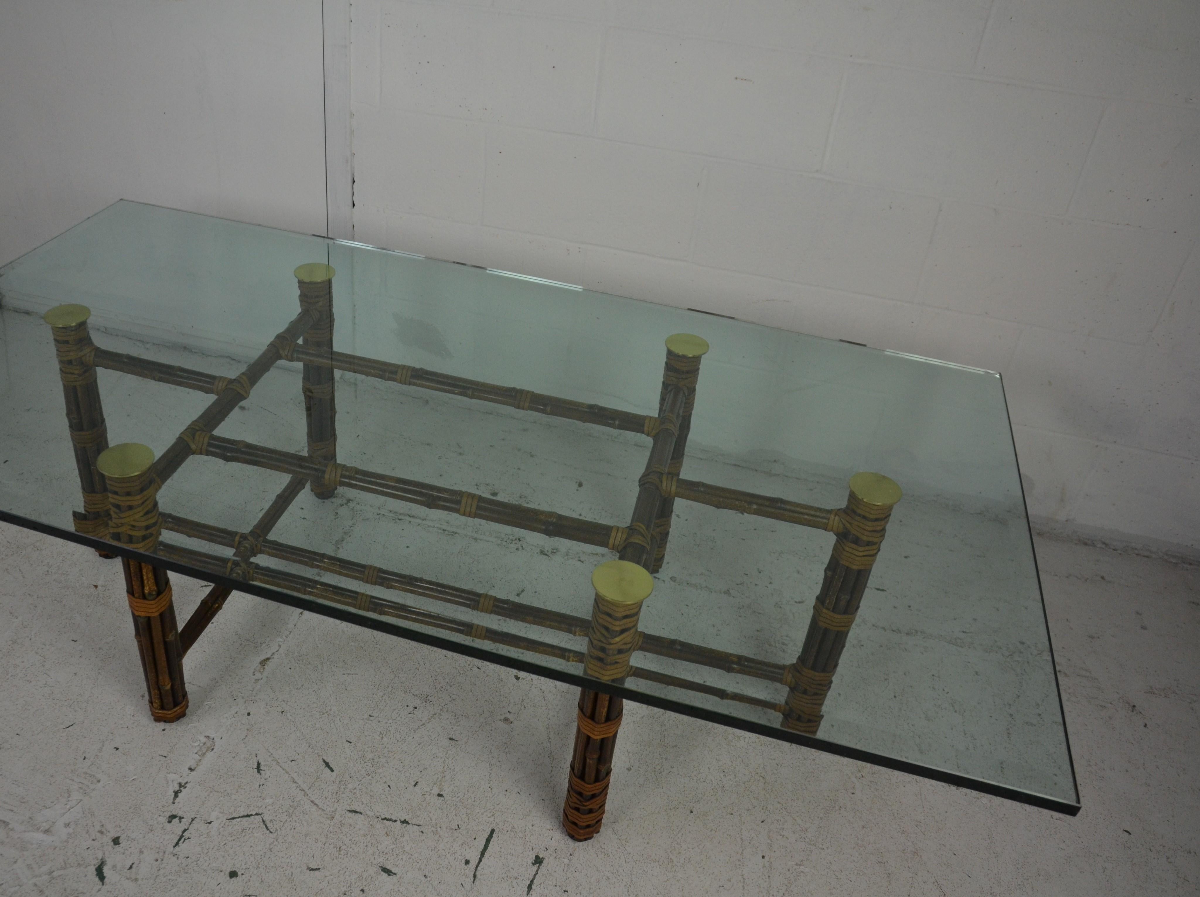 Glass topped Coffee Table by McGuire. The base features six bamboo poles lashed together with McGuire's signature rawhide laces around a steel frame. These legs are joined by horizontal, bundled bamboo stretchers.
 