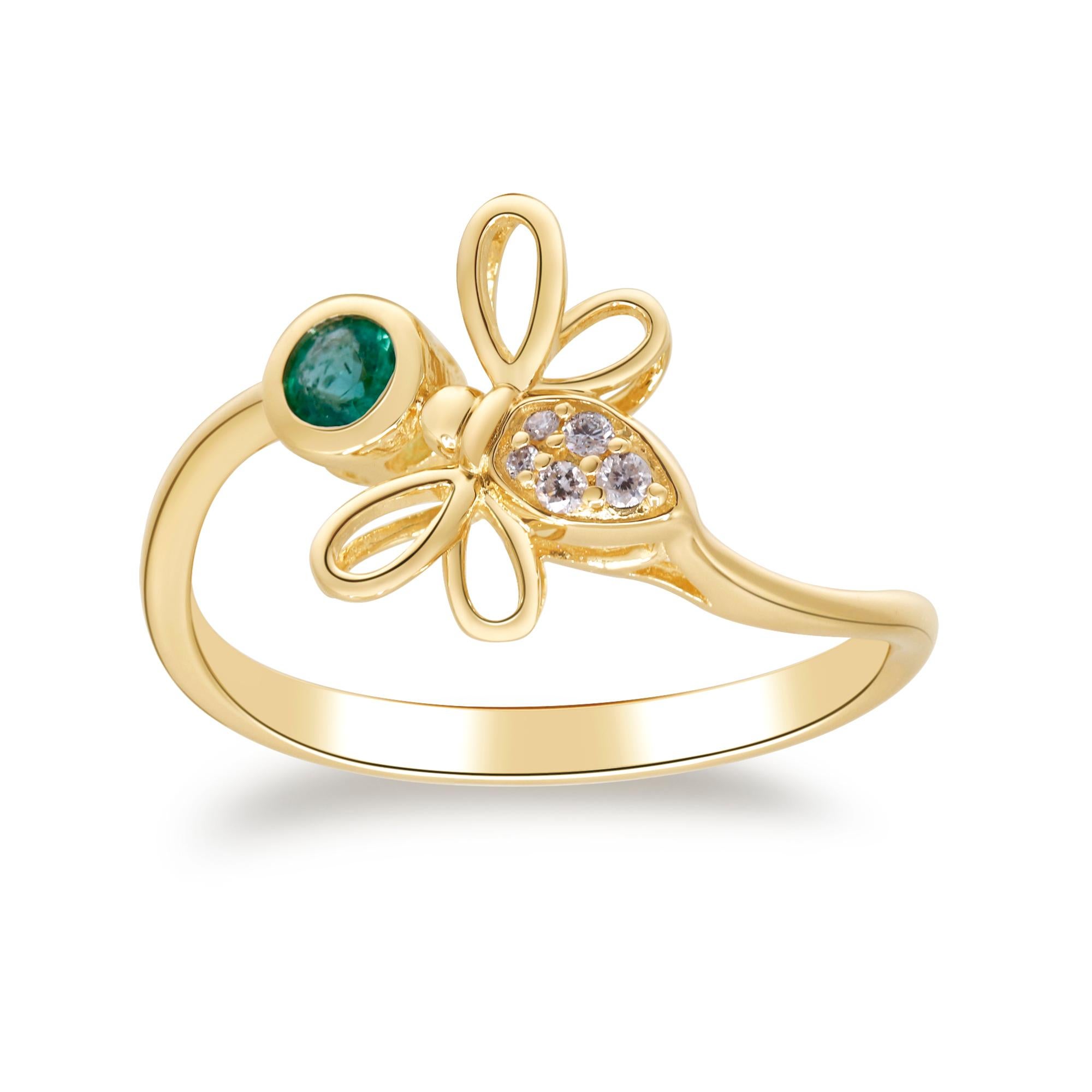 * Mark any occasion with the magical look of this dragon fly ring. Crafted in warm 14K yellow gold, this gracefully designed dragonfly features one sparkling emerald at its center, flanked by delicate filigree wings capped with alluring white