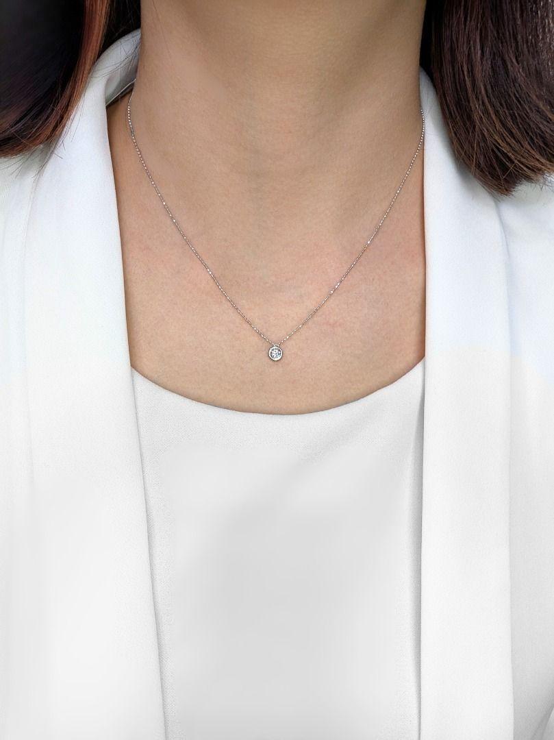 Este collar de segunda mano muestra la belleza intemporal de un único diamante brillante. Un precioso diamante natural de 0,28 quilates, tallado en una clásica forma brillante redonda, ocupa el centro del escenario. El grado G casi incoloro del