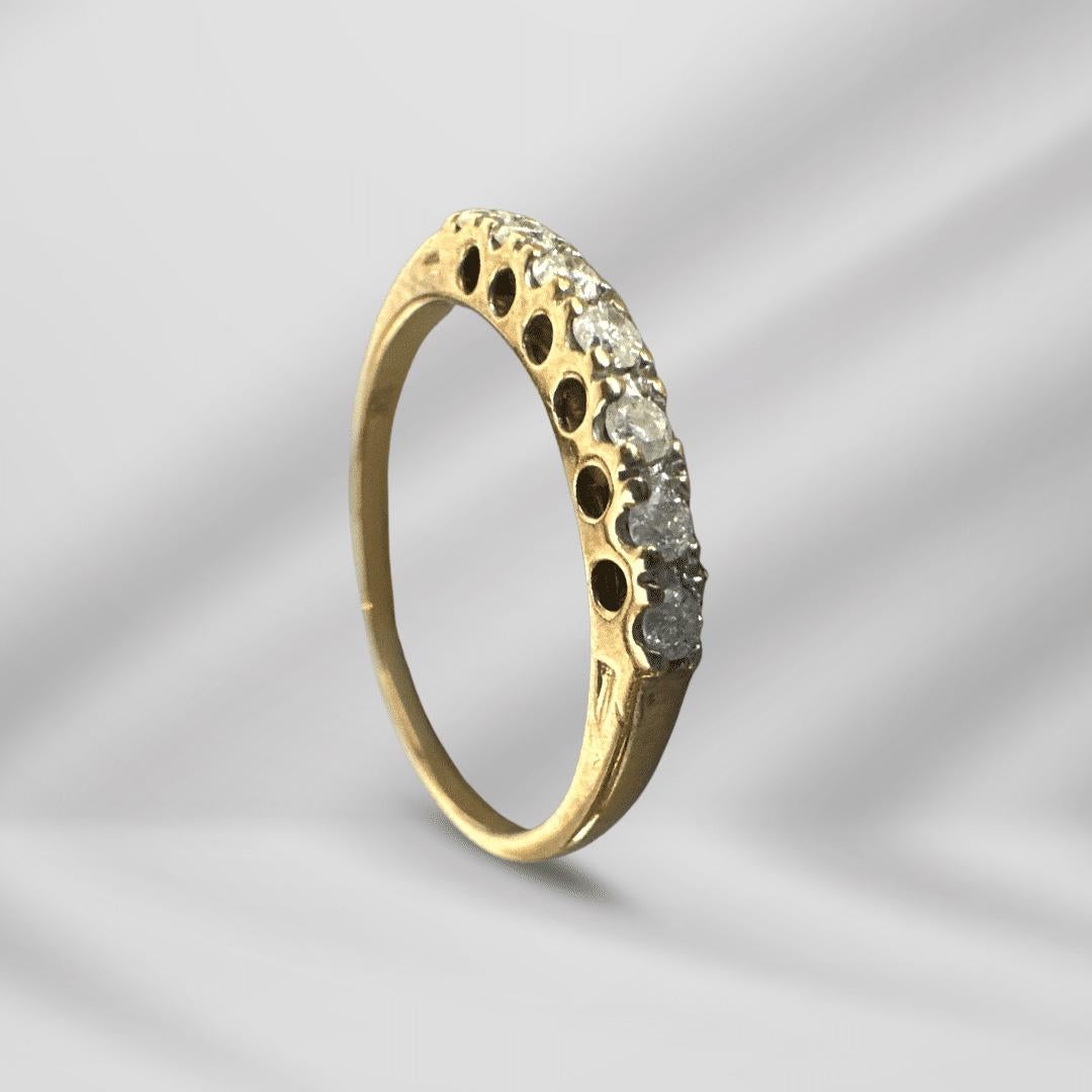 Timeless Design, Understated Elegance
This antique 10K yellow gold ring embodies classic sophistication with a design that is both refined and effortlessly wearable. Featuring seven evenly-sized diamonds set in a graceful line, this piece offers a