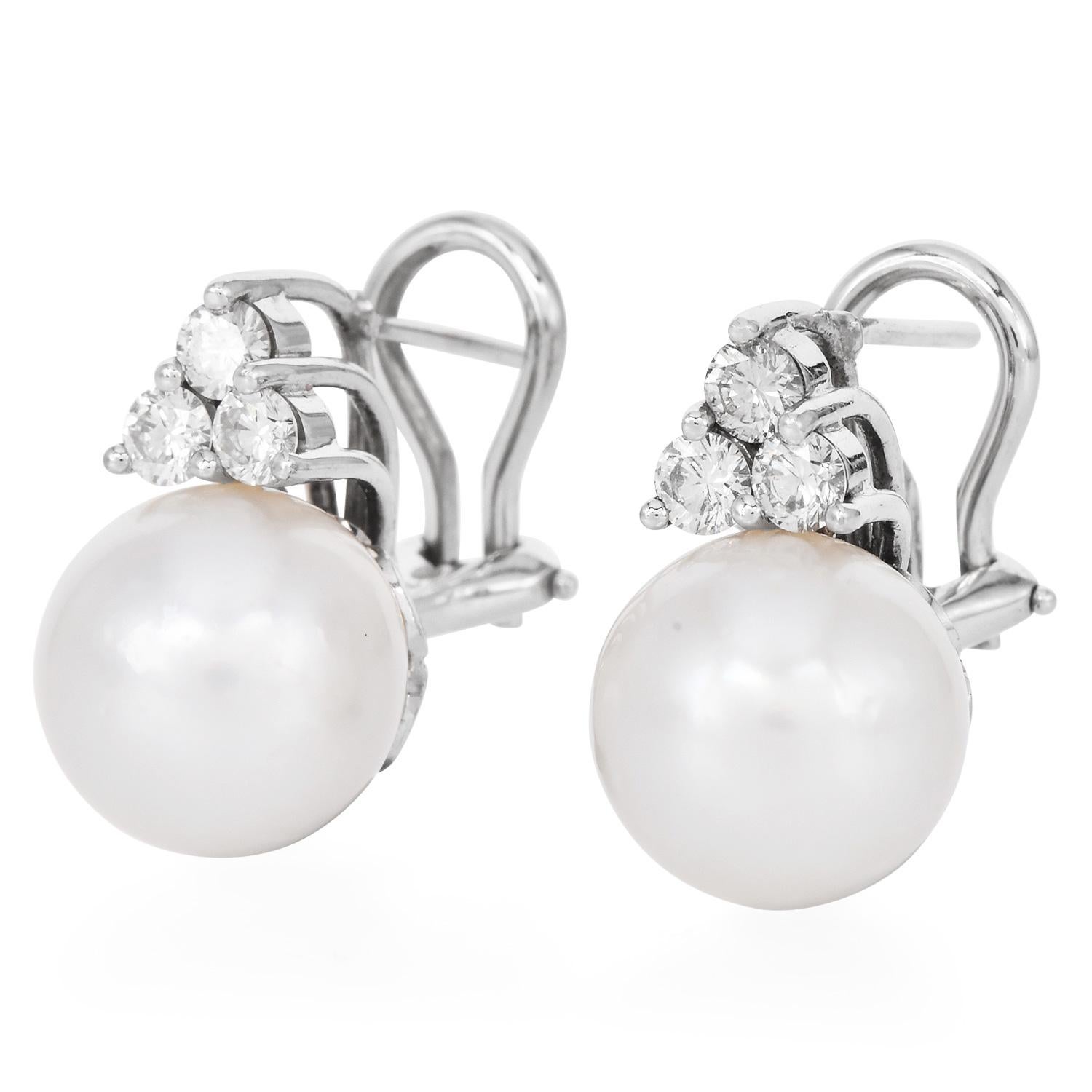
Crafted in solid 18K white gold, they have 2 Fine genuine cultured Pearls, 11 mm, perfectly round with white-silver undertones, high luster & minimum blemishes.
Topped by (6) round-cut, Well-matched extra white fiery Diamonds weighing approximately