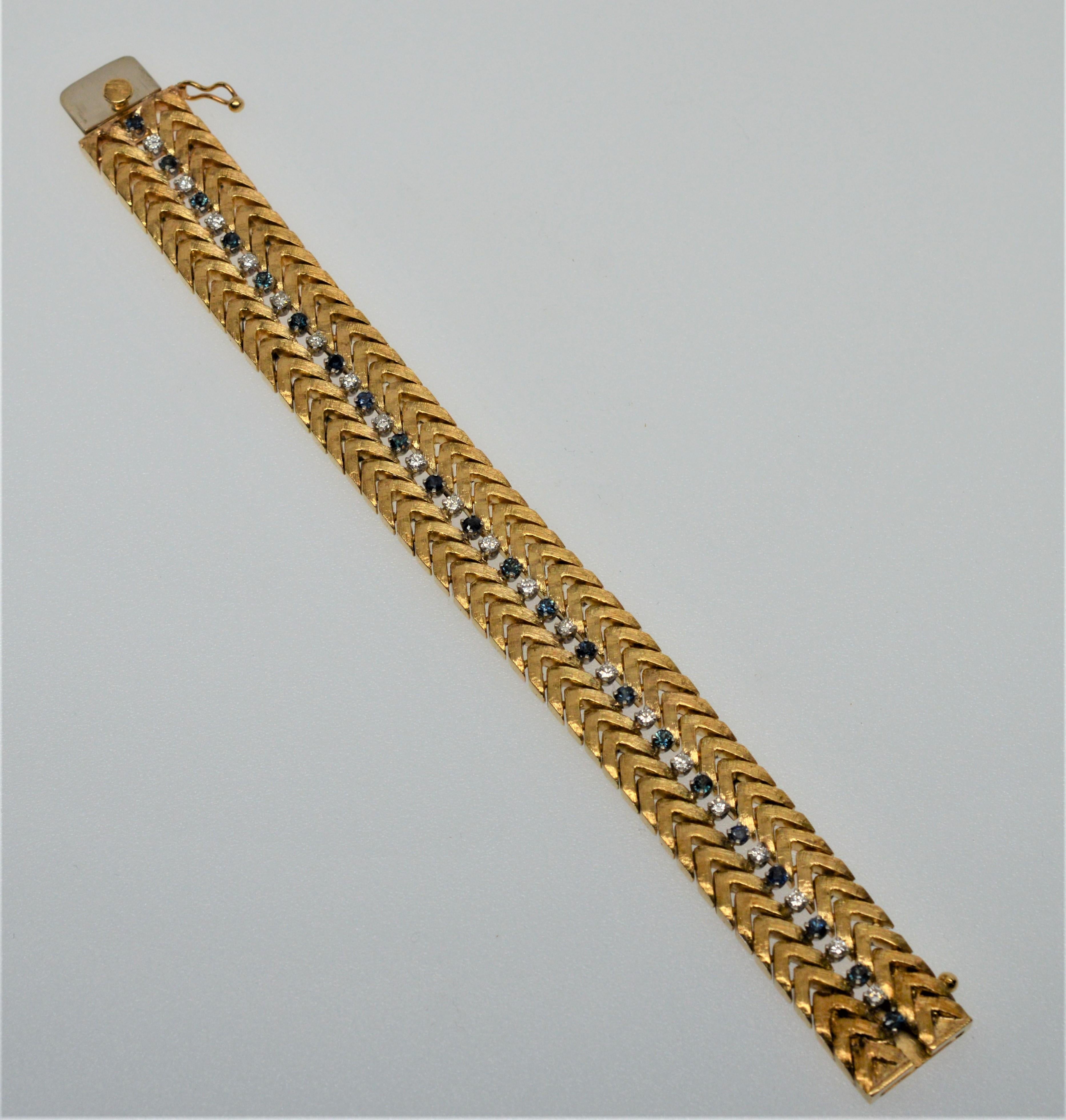 Beautifully constructed in a classic herringbone style with links of elegant satin fourteen karat yellow gold (14K). The bracelet is adorned with a gemstone center line of alternating individually prong set white diamonds, .315 total carat weight