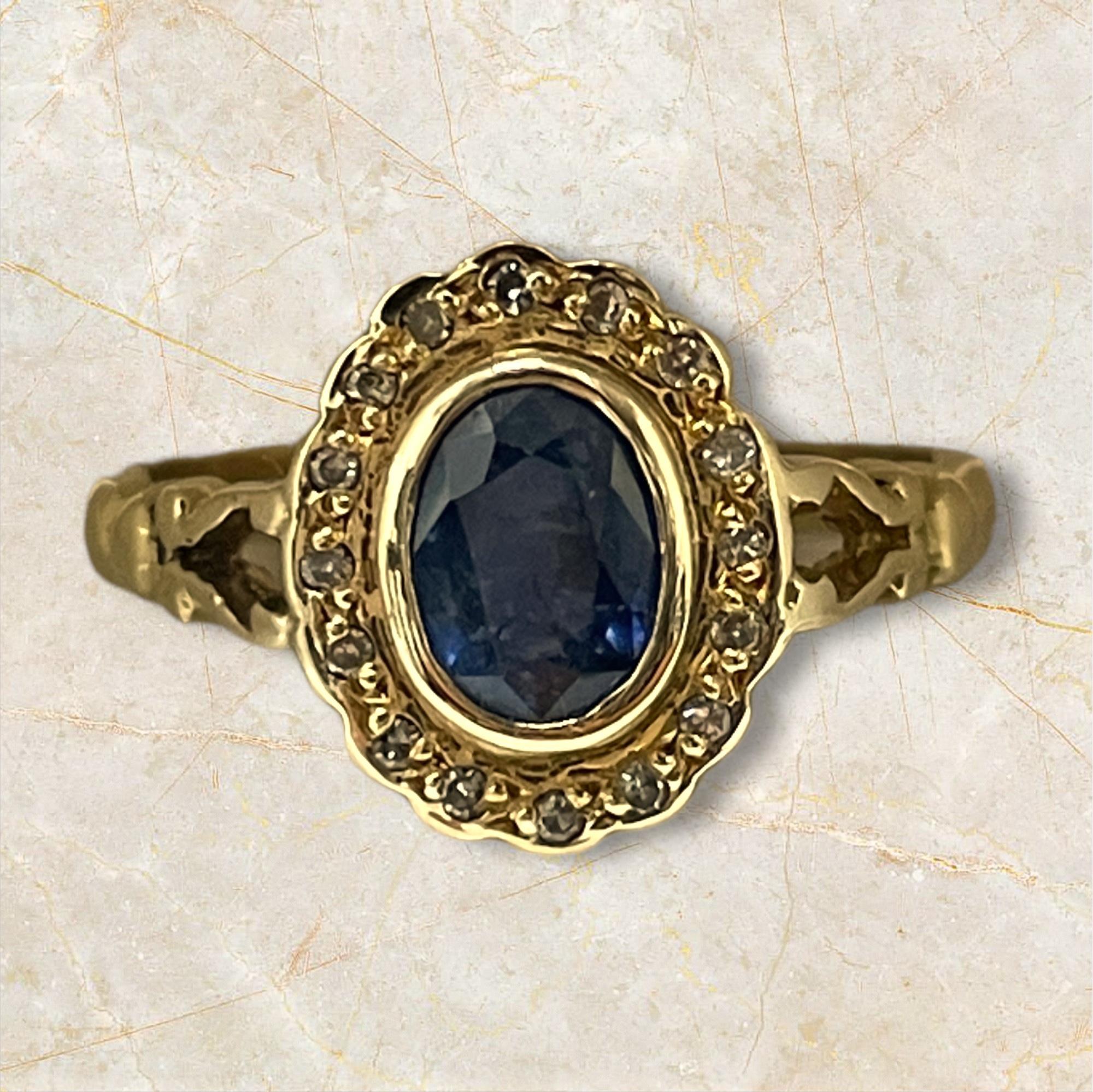 Embrace timeless elegance with this 14K yellow gold ring, featuring a captivating sapphire at its center, surrounded by a halo of sparkling diamonds. The deep blue of the sapphire is beautifully complemented by the warm gold and brilliant diamond