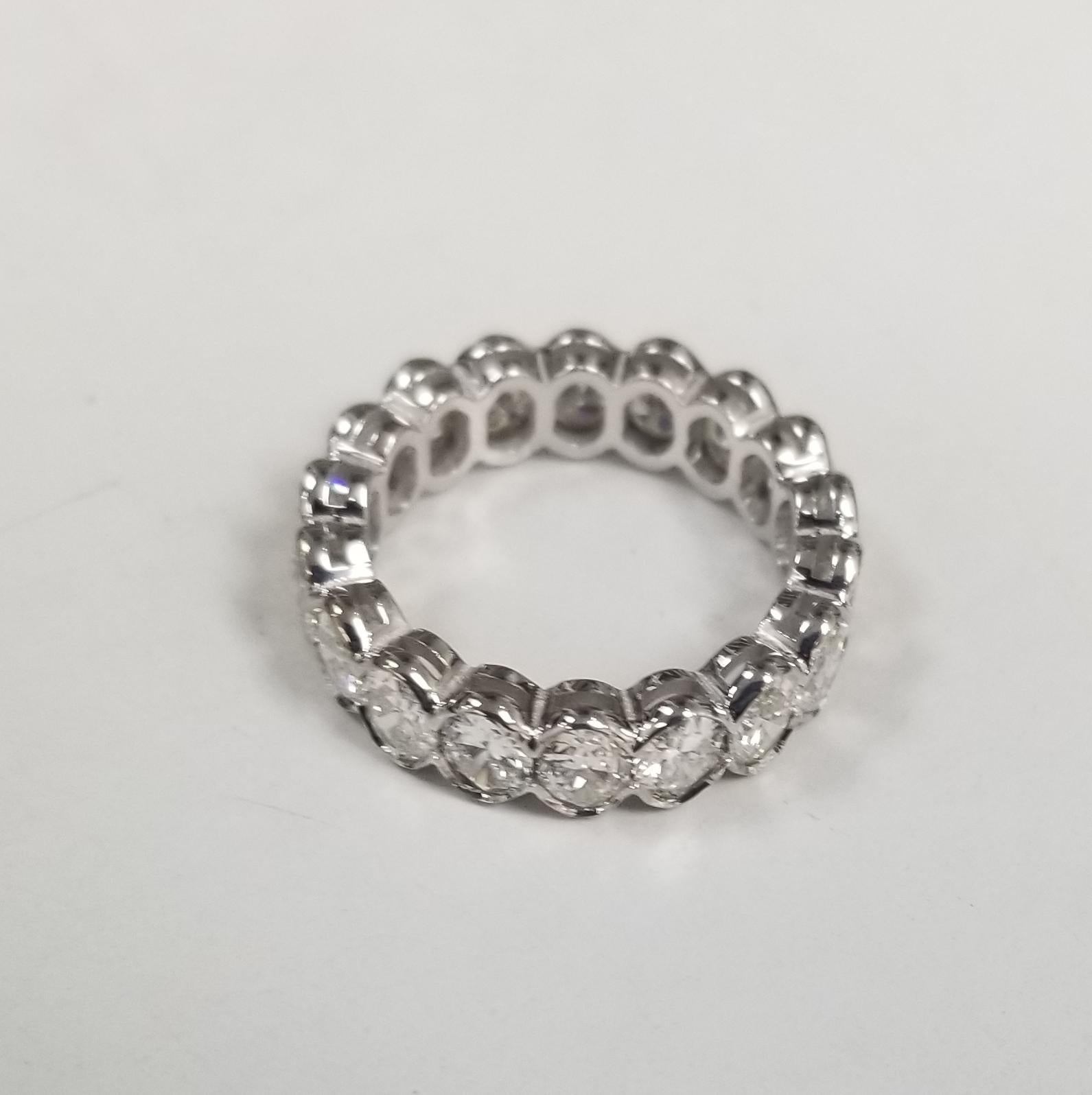 A breathtakingly beautiful diamond wedding band featuring 19 oval cut diamonds set in 14k white gold weighing 4.35carats. These spectacular diamonds are G in color, VS1-2  clarity. This seamless channel set eternity band is expertly crafted surely