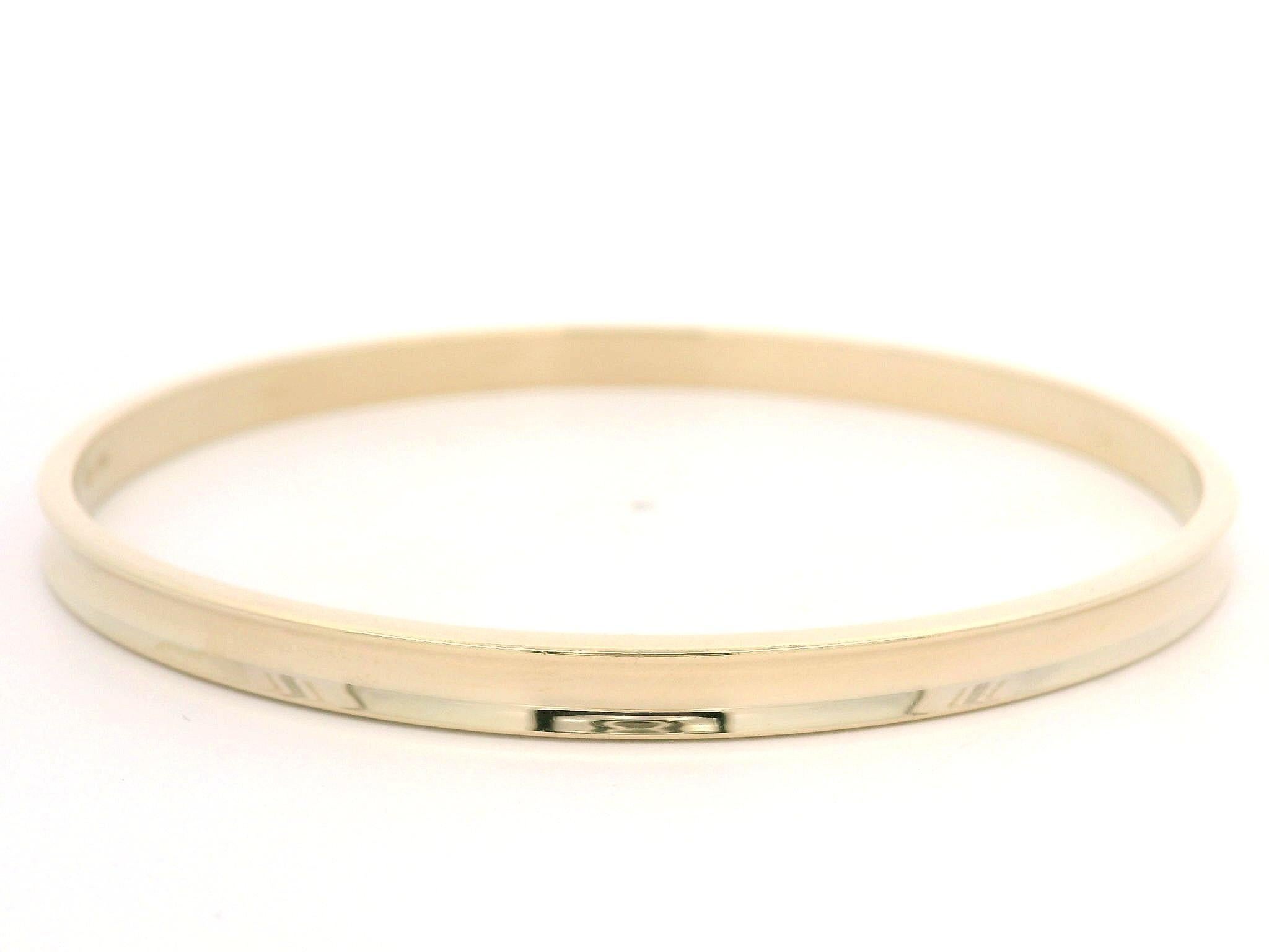 Material: Solid 14k Yellow Gold
Weight: 8.92 Grams
Type: Slip On bangle 
Overall Length: Will comfortably fit up to 7.5” (measured on wrist)
Overall Width: 63.9mm (2.5