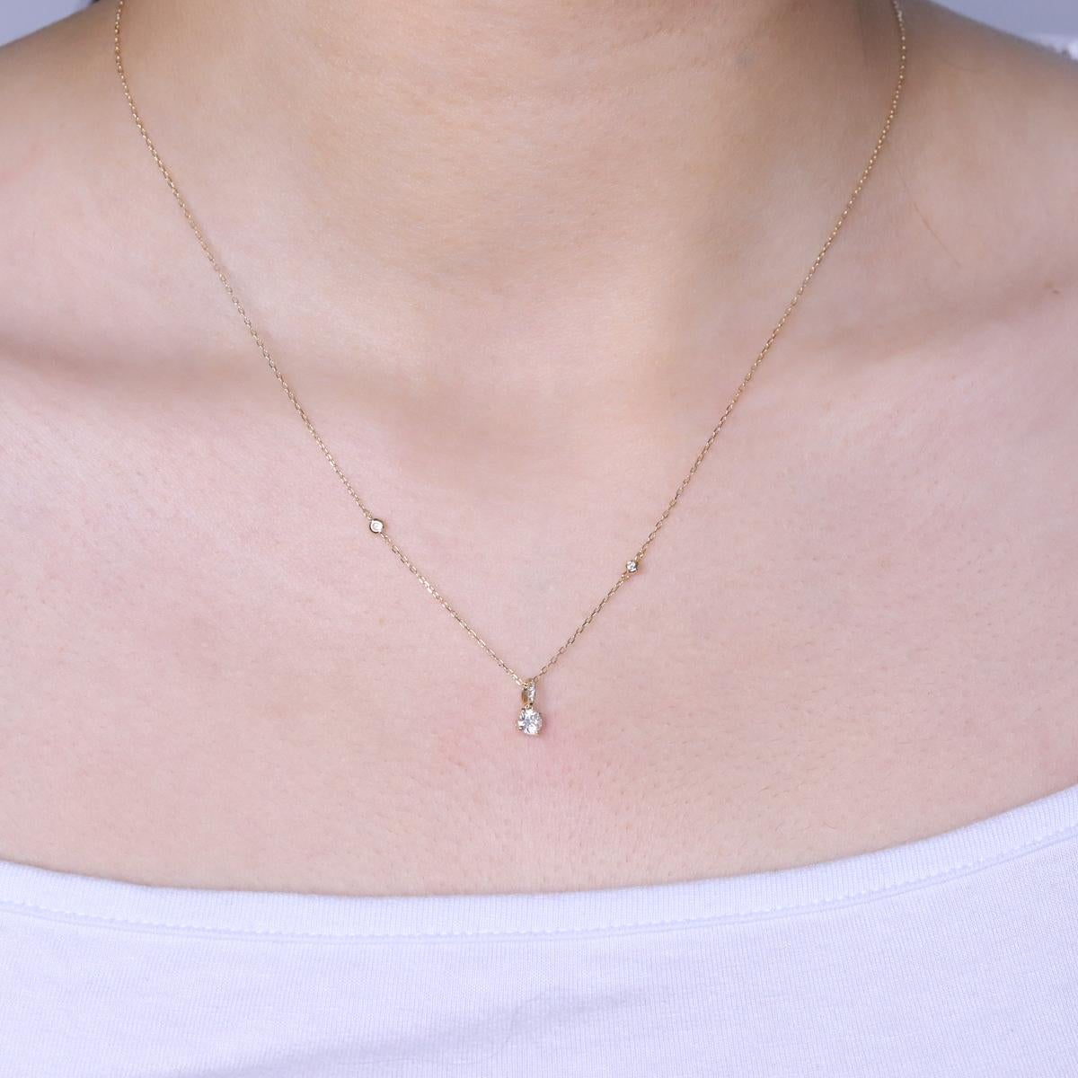 Decorate yourself in elegance with this Pendant is crafted from 14-karat Yellow Gold by Gin & Grace. This Pendant is made up of Round-cut White Diamond (6 Pcs) 0.24 Carat. This Pendant is weight 1.20 grams. This delicate Pendant is polished to a