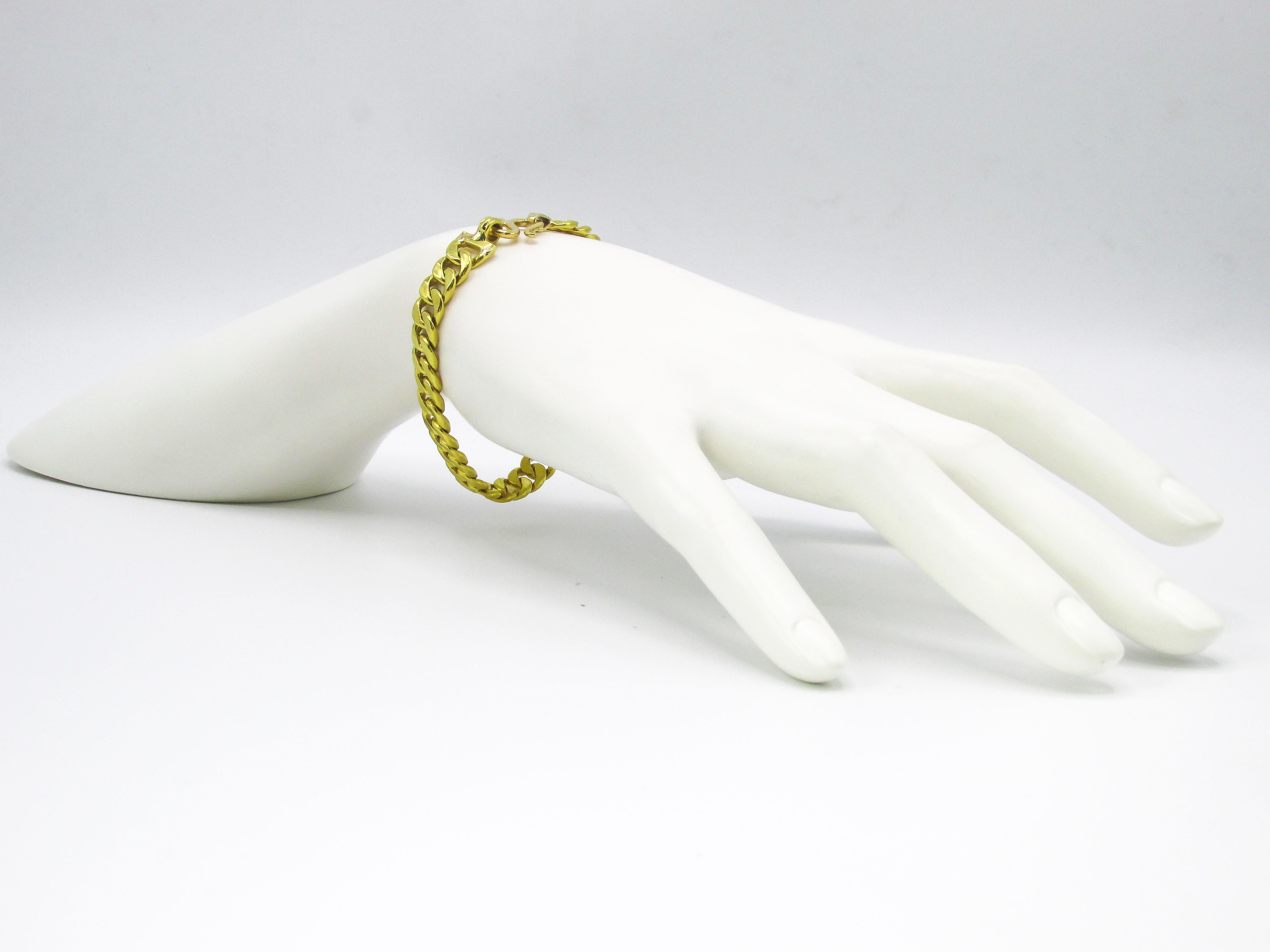 Well handcrafted 18 karat yellow gold flat curb link bracelet secured by an easy to maneuver and comfortable S-shaped hook lock. The elegant yet casual bracelet has a length of 7 inches leaving room for it to flow partially over ones wrist. An