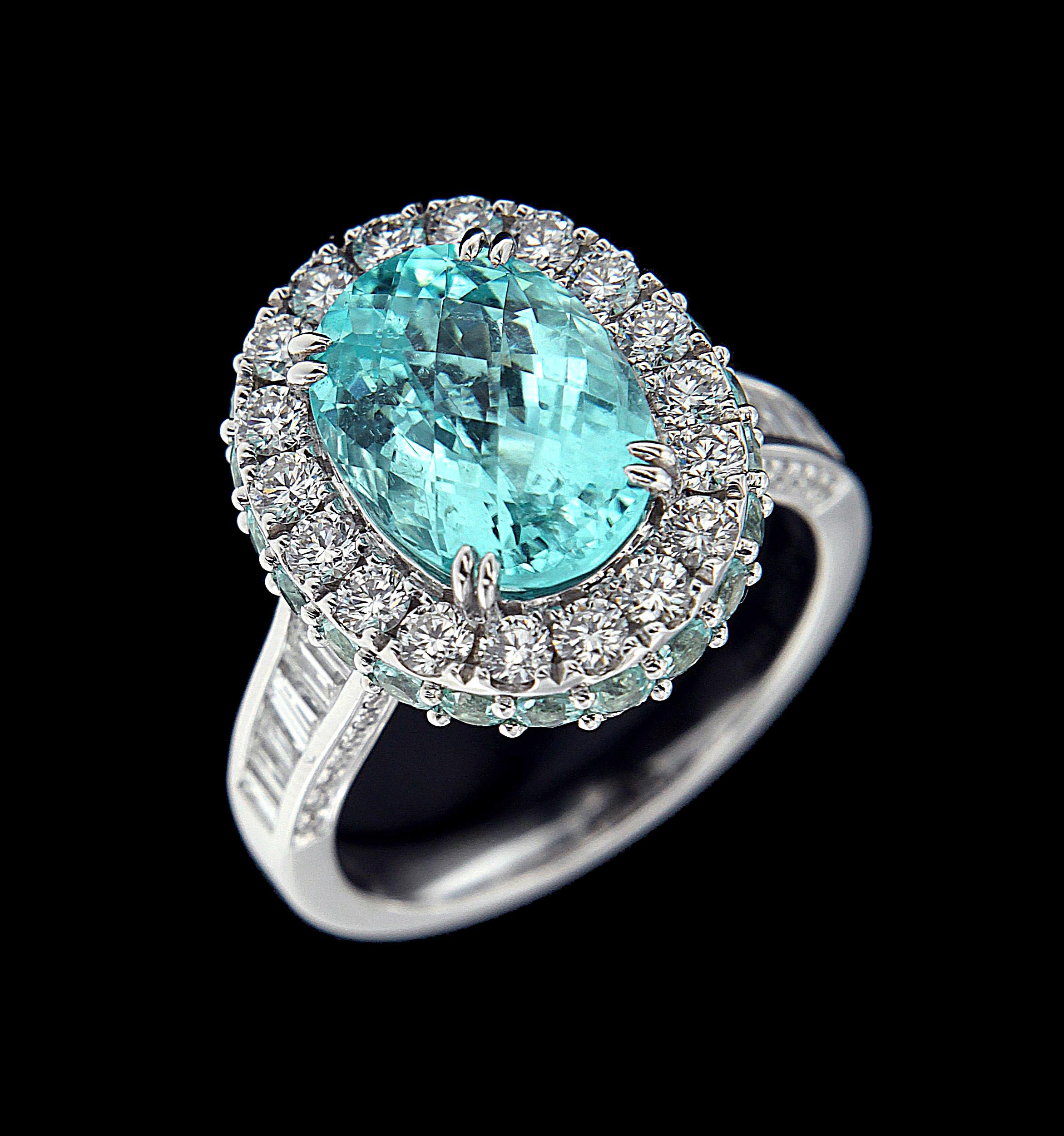Classic 18 Karat White Gold, Dimond And Paraiba Ring 
Rings:
Diamonds of approximately 1.615 carats, semi-precious stones approximately of 5.270 carats mounted on 18 karat white gold ring. The ring weighs approximately around 9.173 grams.


Please