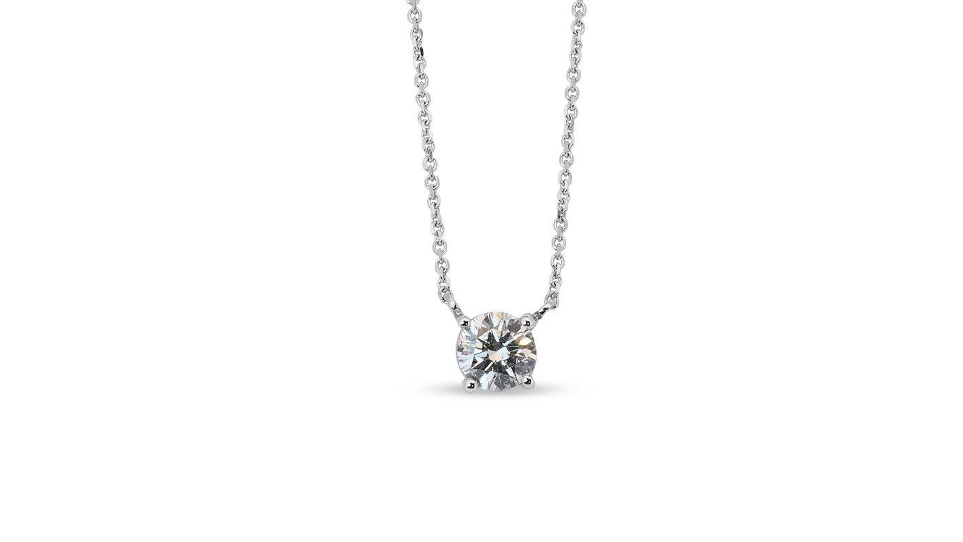 A sophisticated classic solitaire necklace with a dazzling 0.8-carat round brilliant natural diamond in EIF. The jewelry is made of 18k White Gold with a high-quality polish. The main stone is engraved with a laser inscription and has a GIA