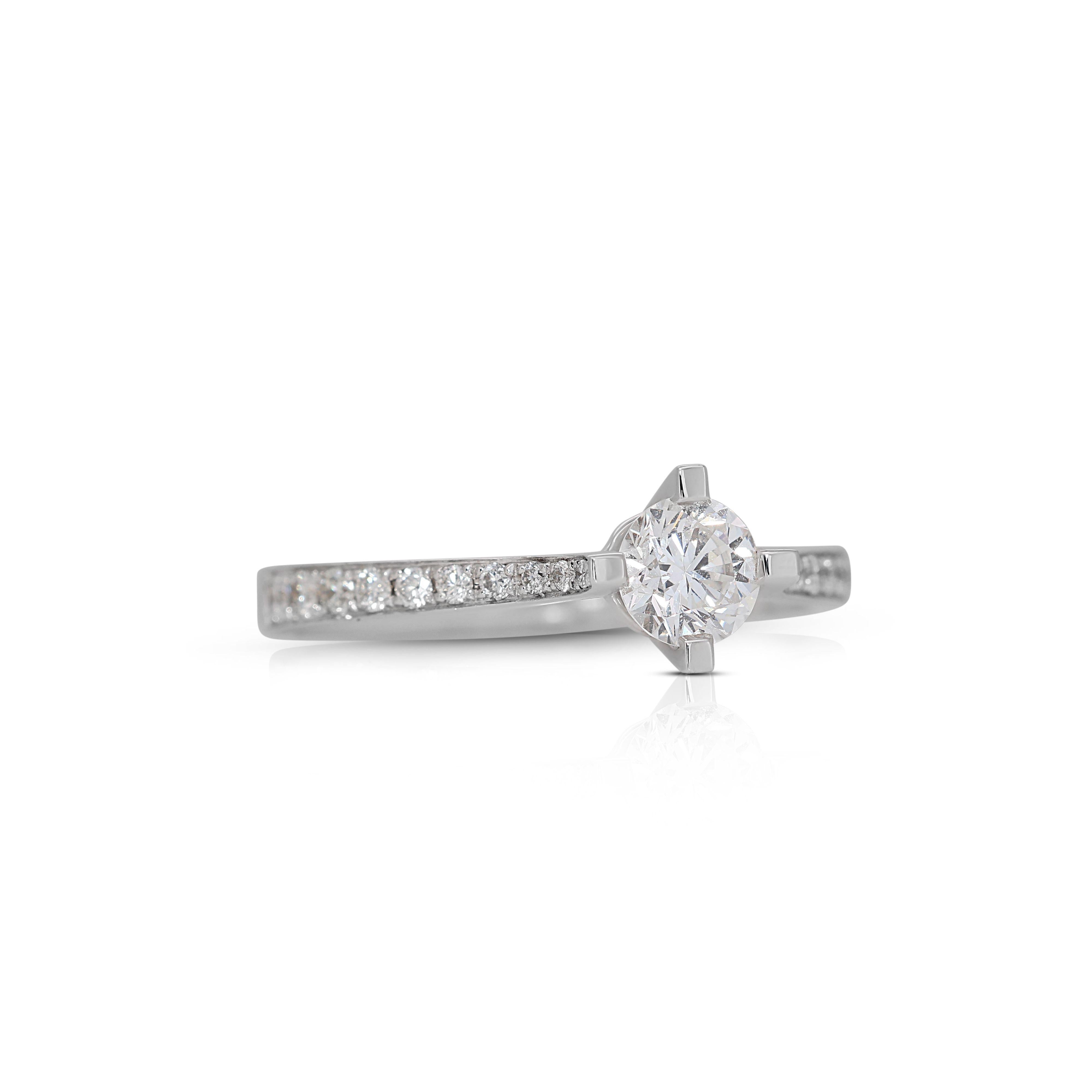 Beautiful 4 Prong Solitaire with Pave Setting made from 18K White Gold with 0.74 total carat of natural round brilliant diamonds. This ring set comes with a GIA certificate for the center stone.

-1 diamond main stone of 0.50 ct.
cut: round