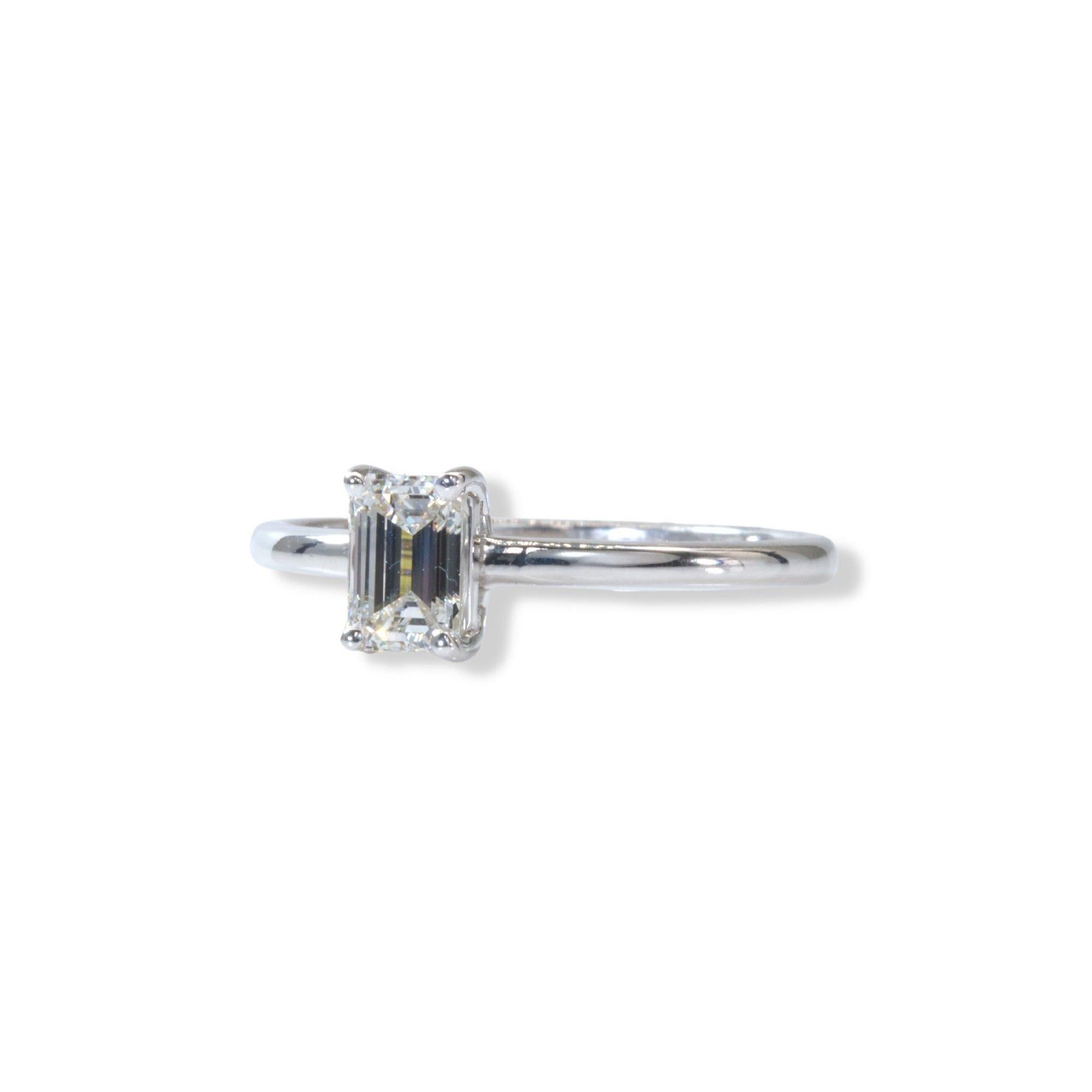 A stunning classic solitaire ring with a dazzling 0.90 carat emerald cut natural diamond. The setting is made of 18K white gold with a high quality polish. The main stone has a laser inscription and a GIA Certificate. It comes with a fancy jewelry