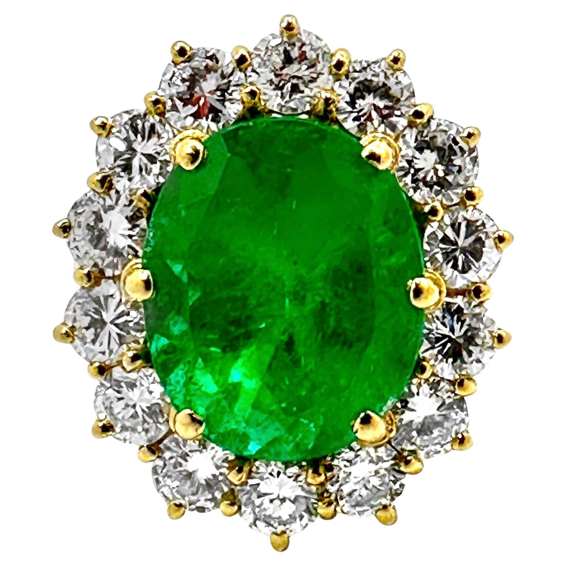 Classic 18K Yellow Gold Cocktail Ring with Oval Emerald Framed by Round Diamonds For Sale