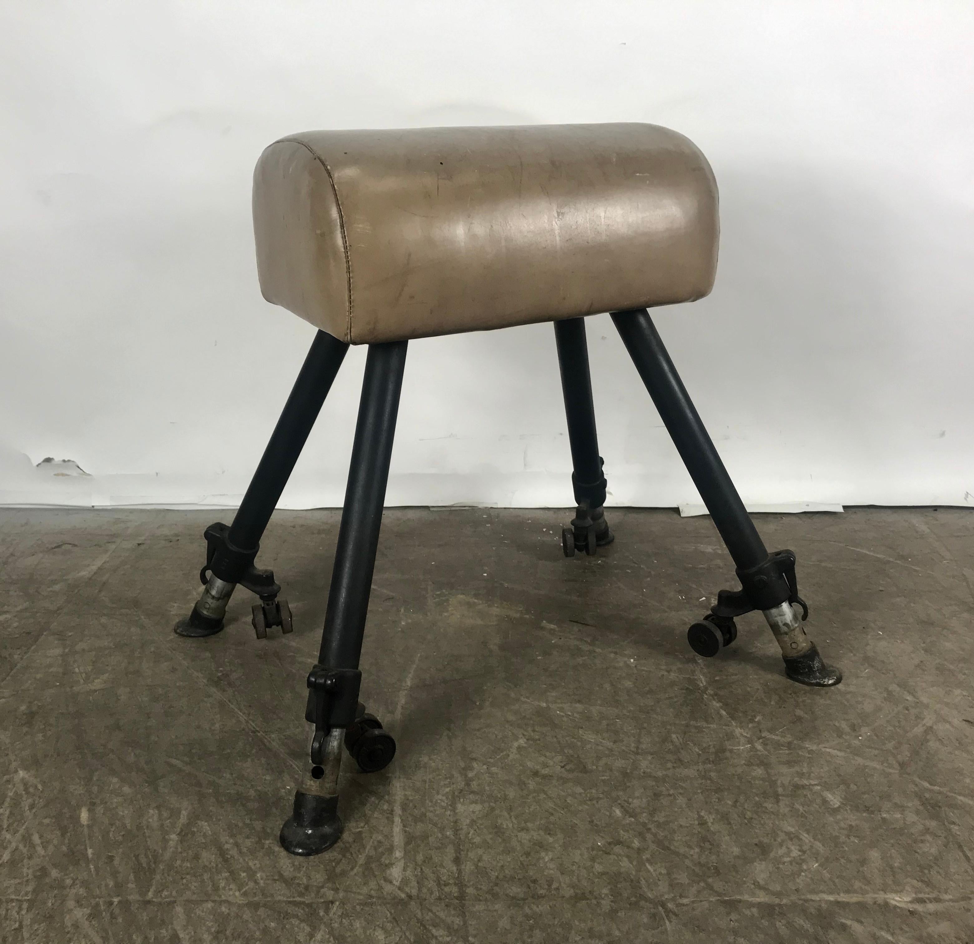Classic 1920s adjustable height leather and cast iron pommel gym horse, amazing design, proportion and patina. Retains original 'HORSE-HOOF