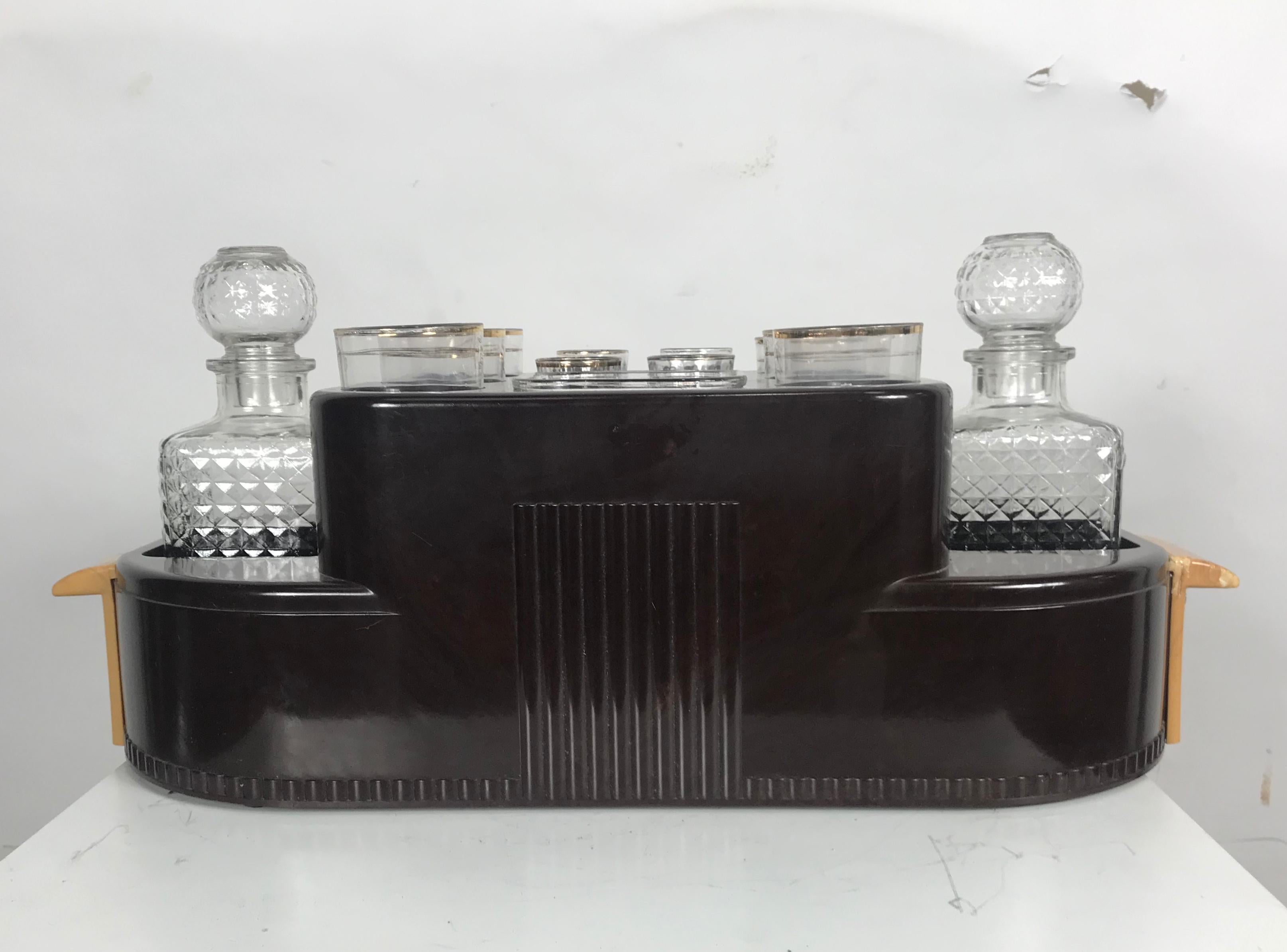 Classic 1930s art deco bakelite portable bar. Two liquor decanters 6 tumblers 4 shot glasses.